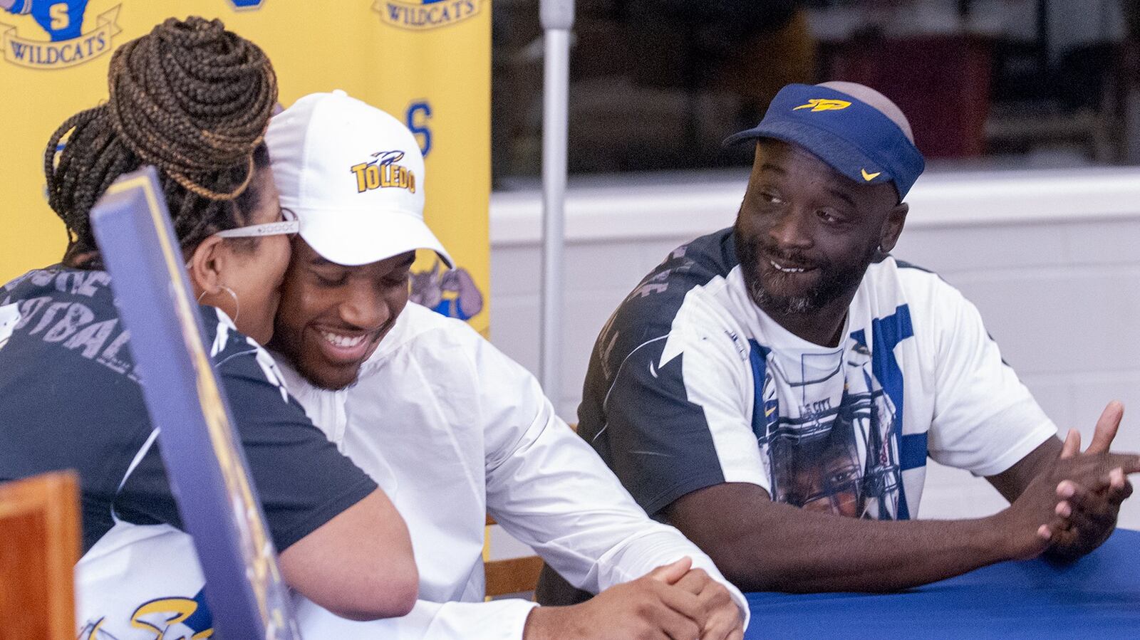 Springfield’s Larry Stephens with parents Larry and Dionna Stephens during signing day ceremony on Wednesday at Springfield High School. Stephens will play college football at Toledo. Jeff Gilbert/CONTRIBUTED