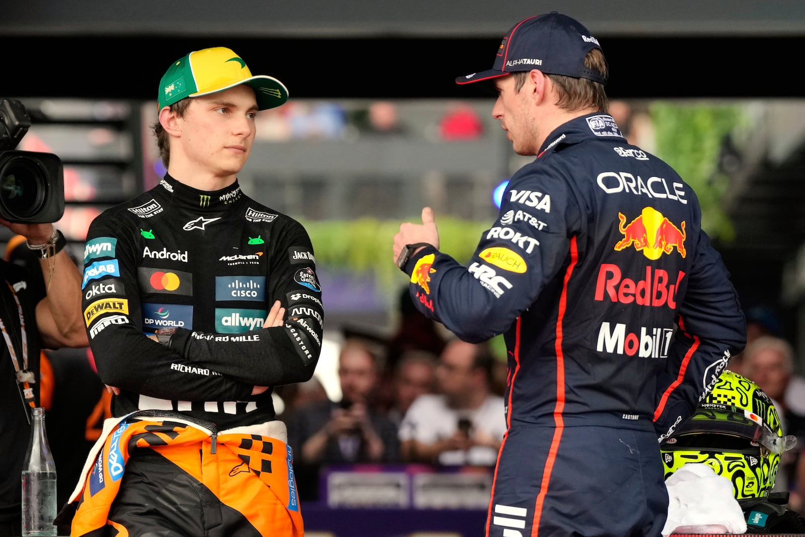 McLaren driver Oscar Piastri, left, of Australia and Red Bull driver Max Verstappen of the Netherlands talk following qualifying at the Australian Formula One Grand Prix at Albert Park, in Melbourne, Australia, Saturday, March 15, 2025. (AP Photo/Asanka Brendon Ratnayake)