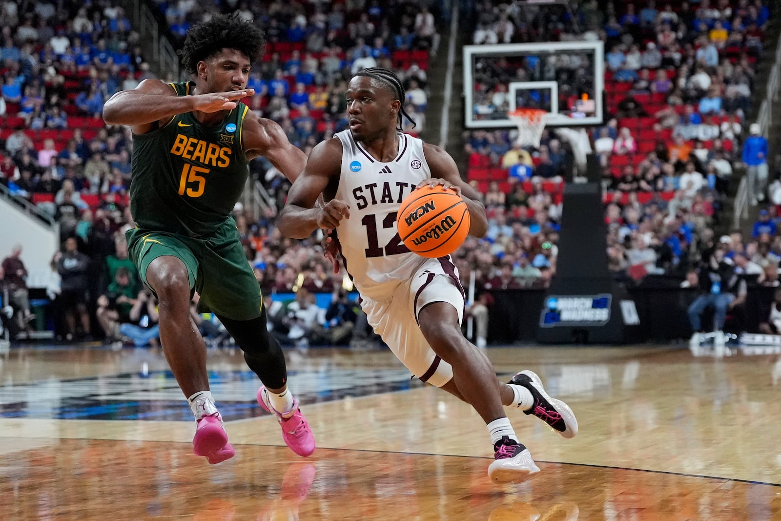 Mississippi State guard Josh Hubbard (12) drives toward the basket past Baylor forward Norchad Omier (15) during the first half in the first round of the NCAA college basketball tournament, Friday, March 21, 2025, in Raleigh, N.C. (AP Photo/Stephanie Scarbrough)