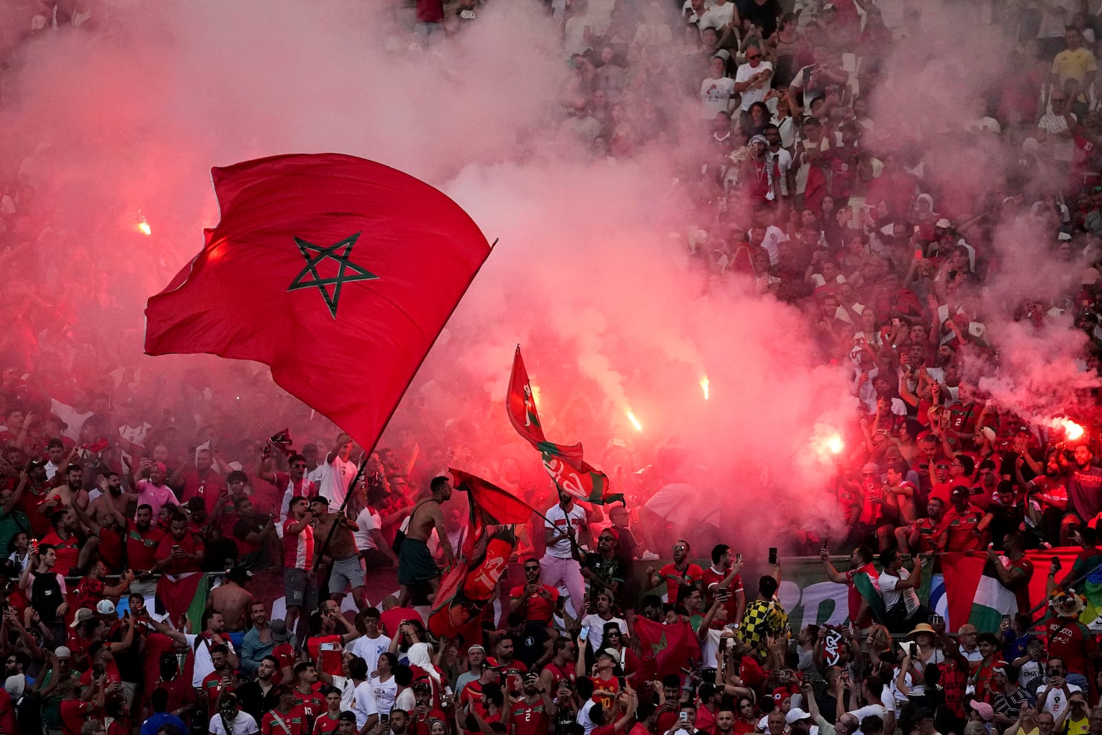 FILE - Morroco fans light flares during a men's semifinal soccer match between Morocco and Spain at the 2024 Summer Olympics, Monday, Aug. 5, 2024, at Marseille Stadium in Marseille, France. (AP Photo/Daniel Cole, File)