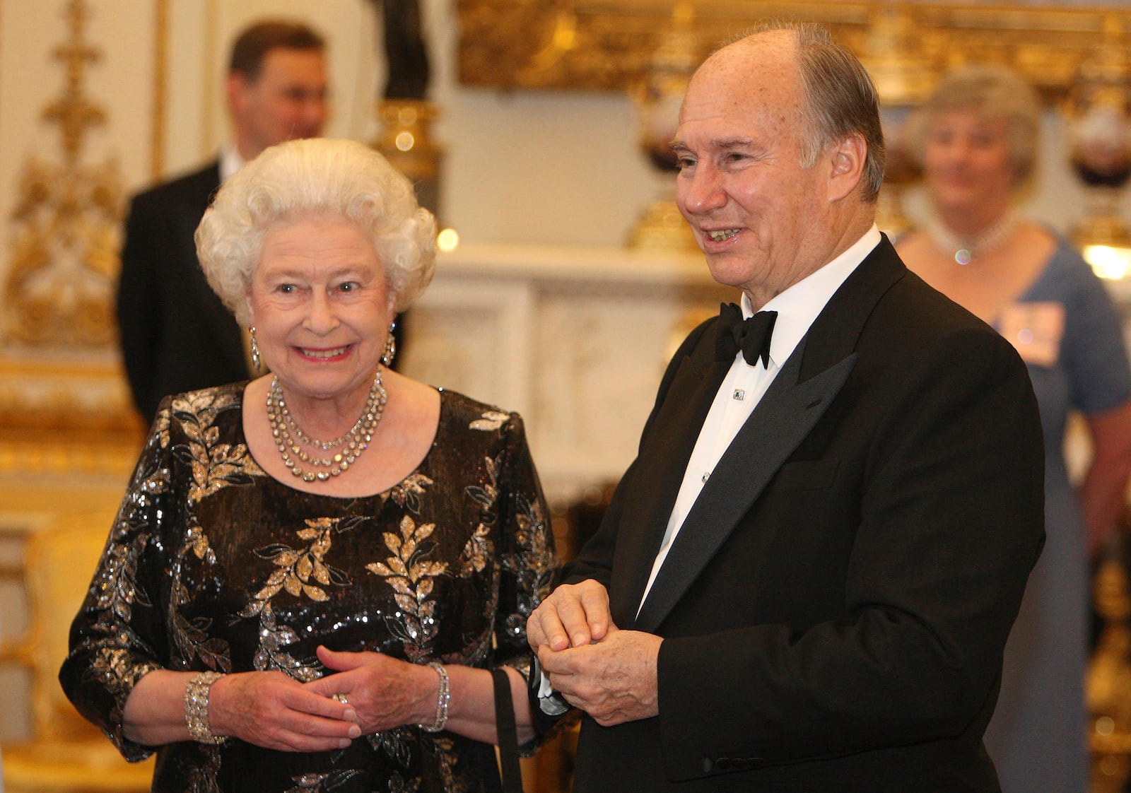 FILE - Queen Elizabeth II and The Aga Khan at a dinner at Buckingham Palace, in London, July 7, 2008, to mark the Aga Khan's Golden Jubilee. (Dominic Lipinski/PA via AP, File)