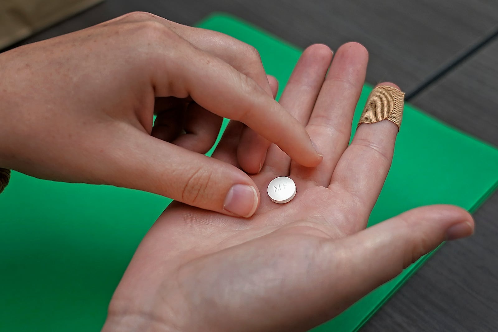 FILE - A patient prepares to take the first of two combination pills, mifepristone, for a medication abortion during a visit to a clinic in Kansas City, Kan., Oct. 12, 2022. (AP Photo/Charlie Riedel, File)