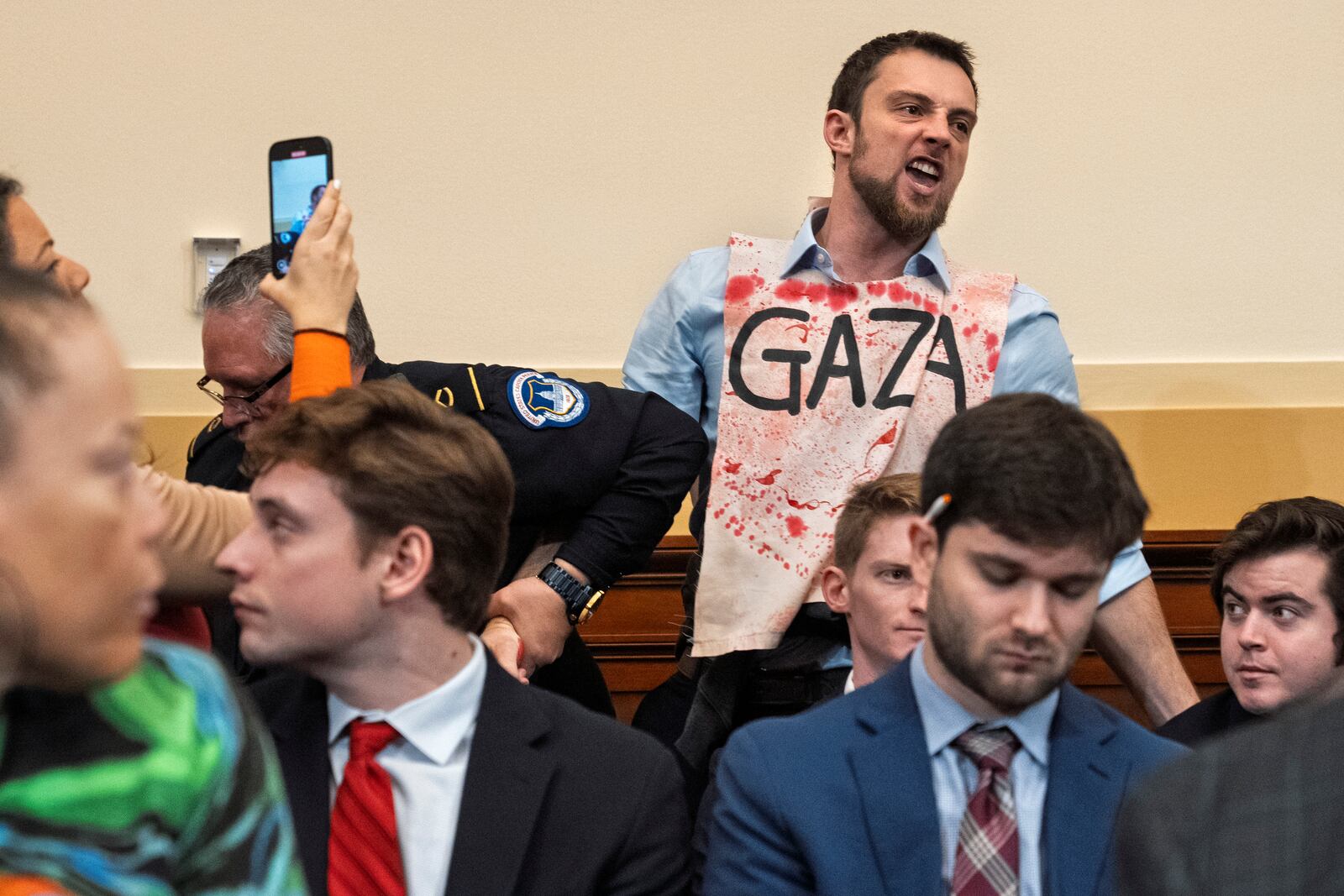 A Gaza protester screams at Secretary of State Antony Blinken as he testifies during a House Committee on Foreign Affairs hearing on the US withdrawal from Afghanistan, Wednesday, Dec. 11, 2024, on Capitol Hill in Washington. (AP Photo/Jacquelyn Martin)