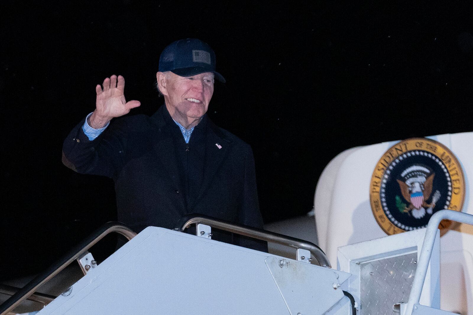 President Joe Biden waves as he boards Air Force One at Nantucket Memorial Airport, Mass., Saturday, Nov. 30, 2024, en route to Washington. (AP Photo/Jose Luis Magana)