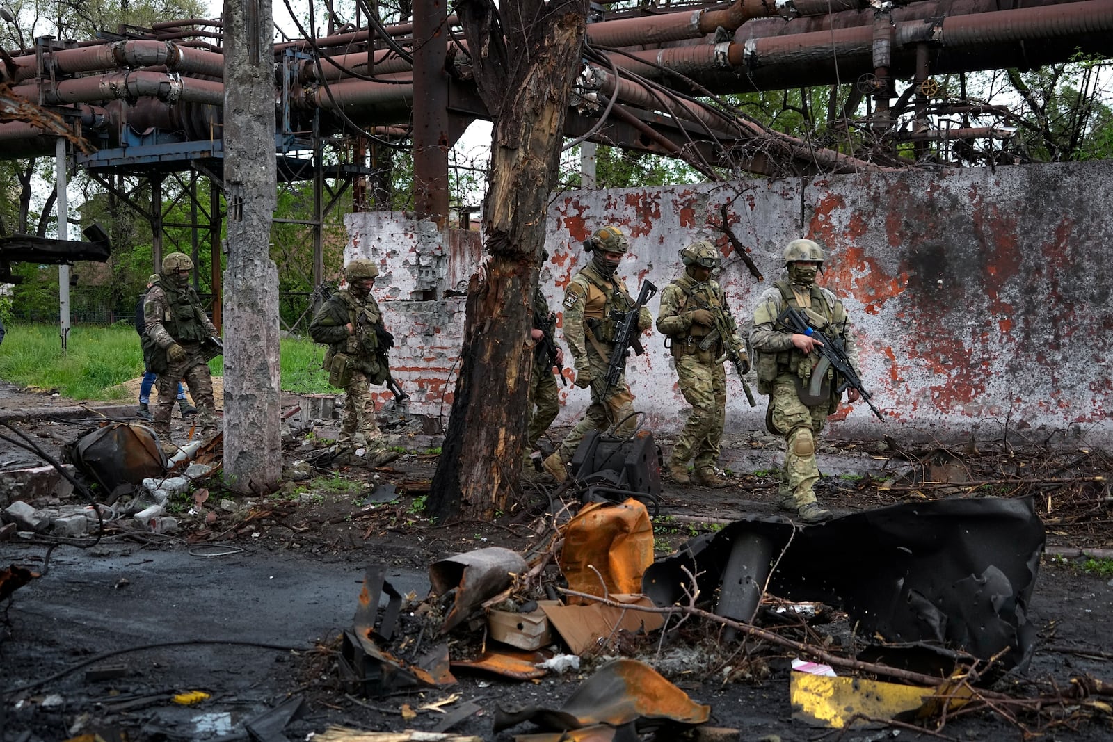 FILE - Russian troops walk in a destroyed part of the Illich Iron & Steel Works Metallurgical Plant in the city of Mariupol in the Donetsk region of eastern Ukraine, on May 18, 2022. (AP Photo, File)