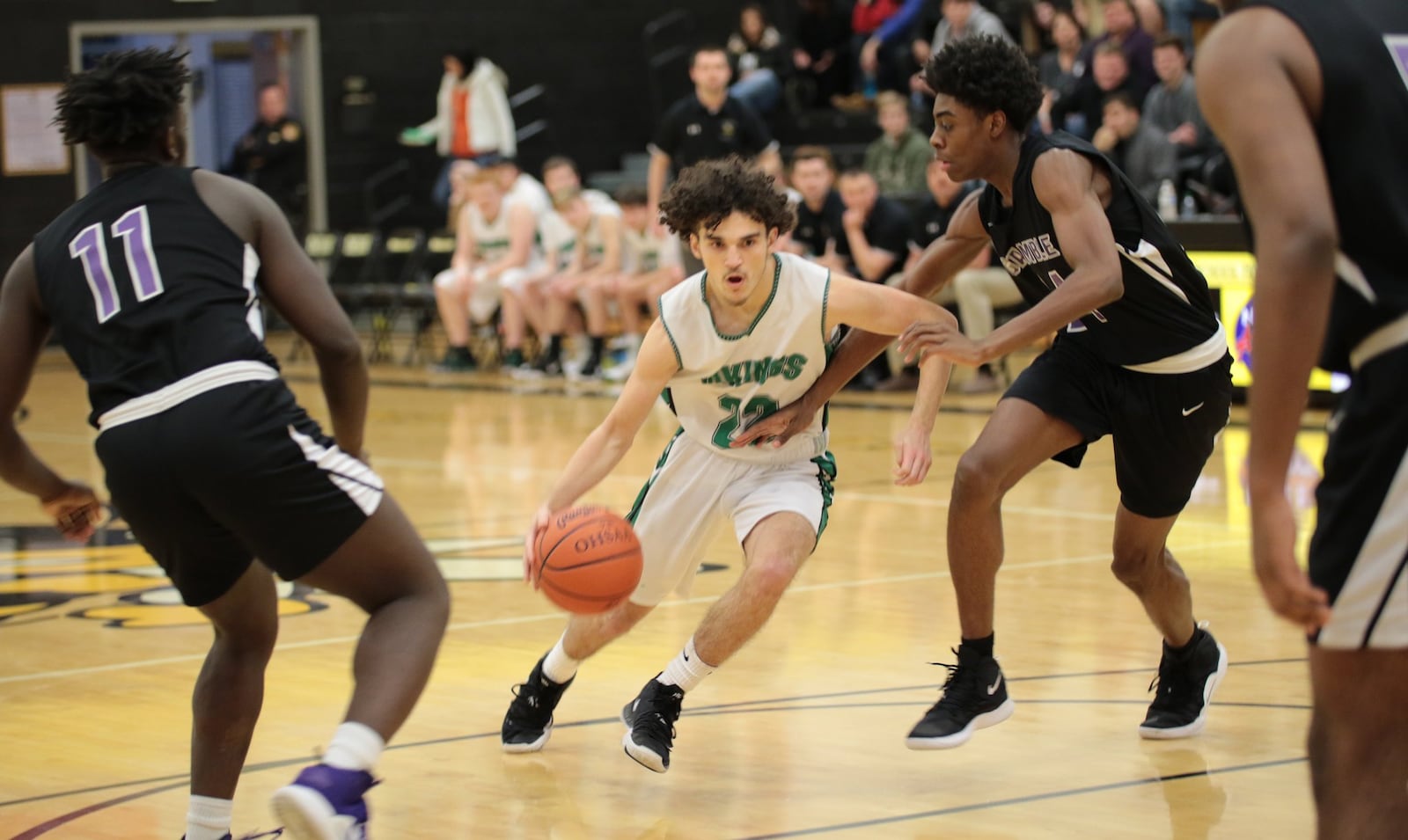 New Miami’s Jordan Robinette drives through the Gamble Montessori defense during last Saturday’s Division IV district basketball semifinal at Taylor. Robinette hit the game-winning shot as New Miami won 48-47. PHOTO BY KRAE/WWW.KRAEPHOTOGRRAPHY.COM