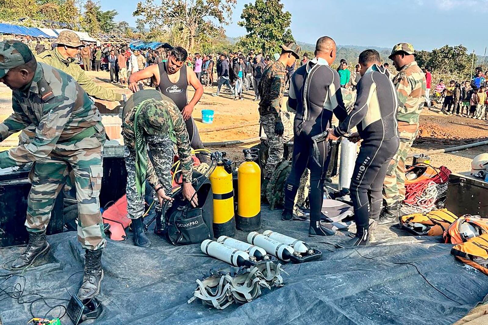 This image provided by Indian Army shows soldiers preparing their equipment to rescue workers who are trapped inside a coal mine, in Umrangso area of Dimapur Hasao district in northeastern state of Assam, India, Tuesday, Jan. 7, 2025. (Indian Army via AP)