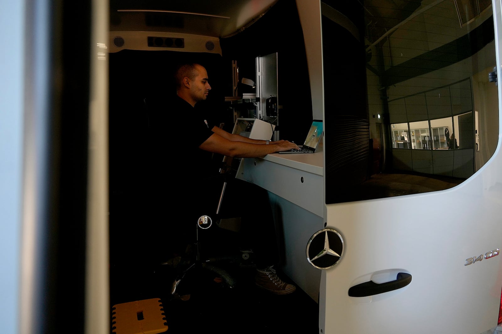 Charalambos Madritis sits in front of a computer laptop inside a specially configured van equipped with highly sensitive sensors able to detect radioactive materials, parked inside the U.S.-funded Cyprus Center for Land, Open Seas and Port Security (CYCLOPS) in Larnaca, Cyprus on Monday, Nov. 4, 2024. (AP Photo/Petros Karadjias)