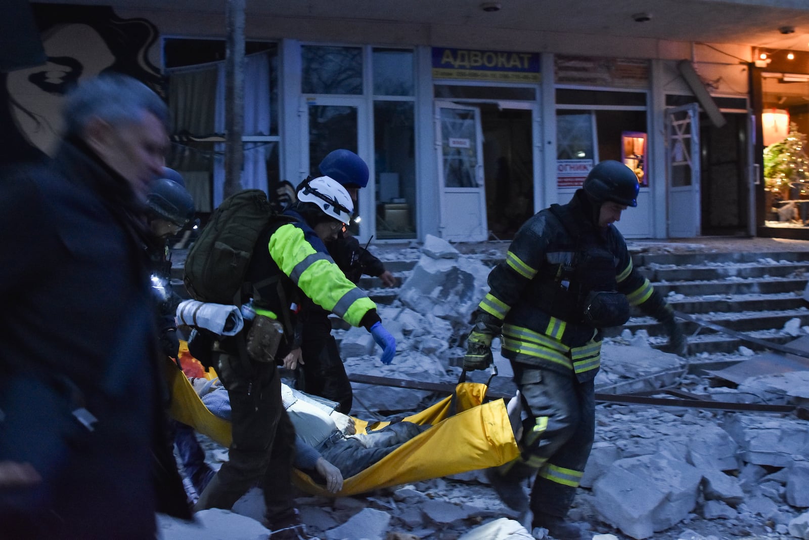 Rescuers carry a wounded civilian after a Russian missile hit a private medical clinic in Zaporizhzhia, Ukraine, Tuesday, Dec. 10, 2024. (AP Photo/Andriy Andriyenko)