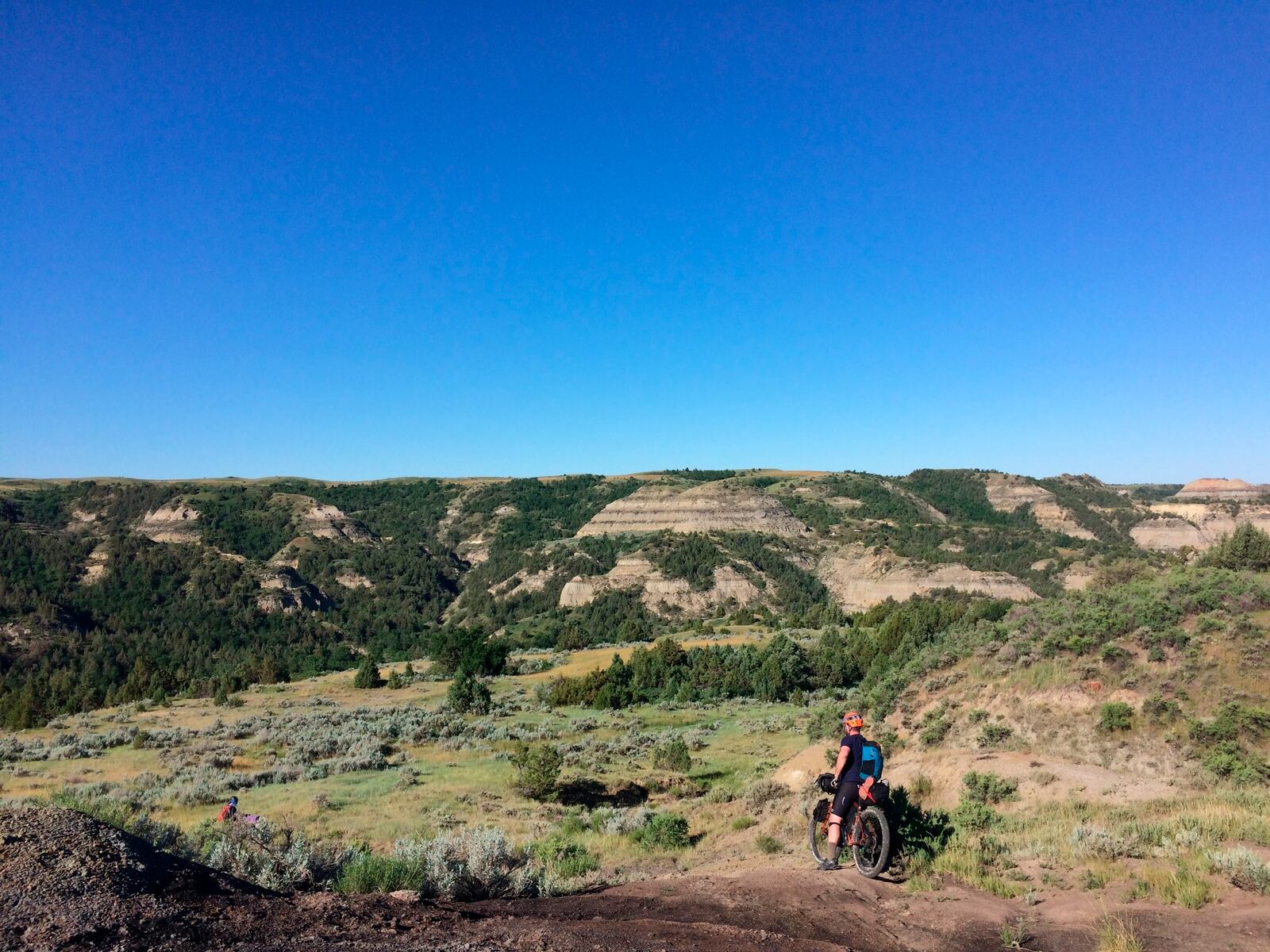 FILE - Drew Redman takes a break along the Maah Daah Hey Trail on June 19, 2017, in the North Dakota Badlands. (AP Photo/Carey J. Williams, File)