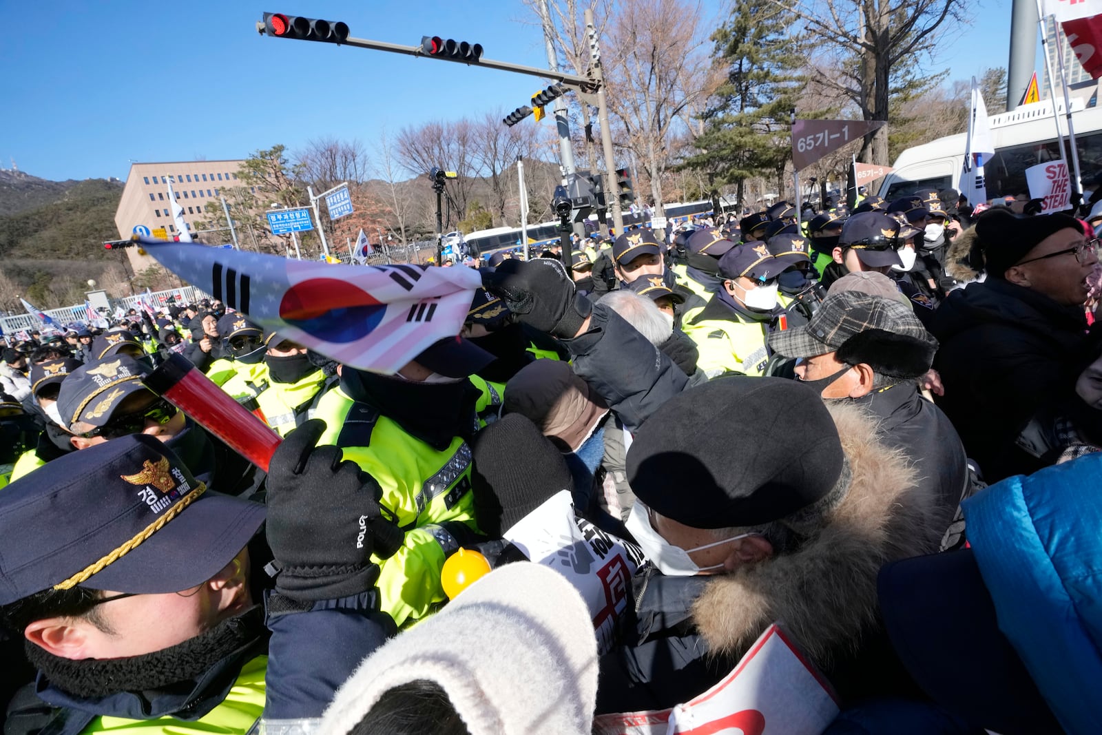 Supporters of impeached South Korean President Yoon Suk Yeol struggle with police officers during a rally to oppose his impeachment near the Corruption Investigation Office for High-Ranking Officials in Gwacheon, South Korea, Wednesday, Jan. 15, 2025. (AP Photo/Ahn Young-joon)