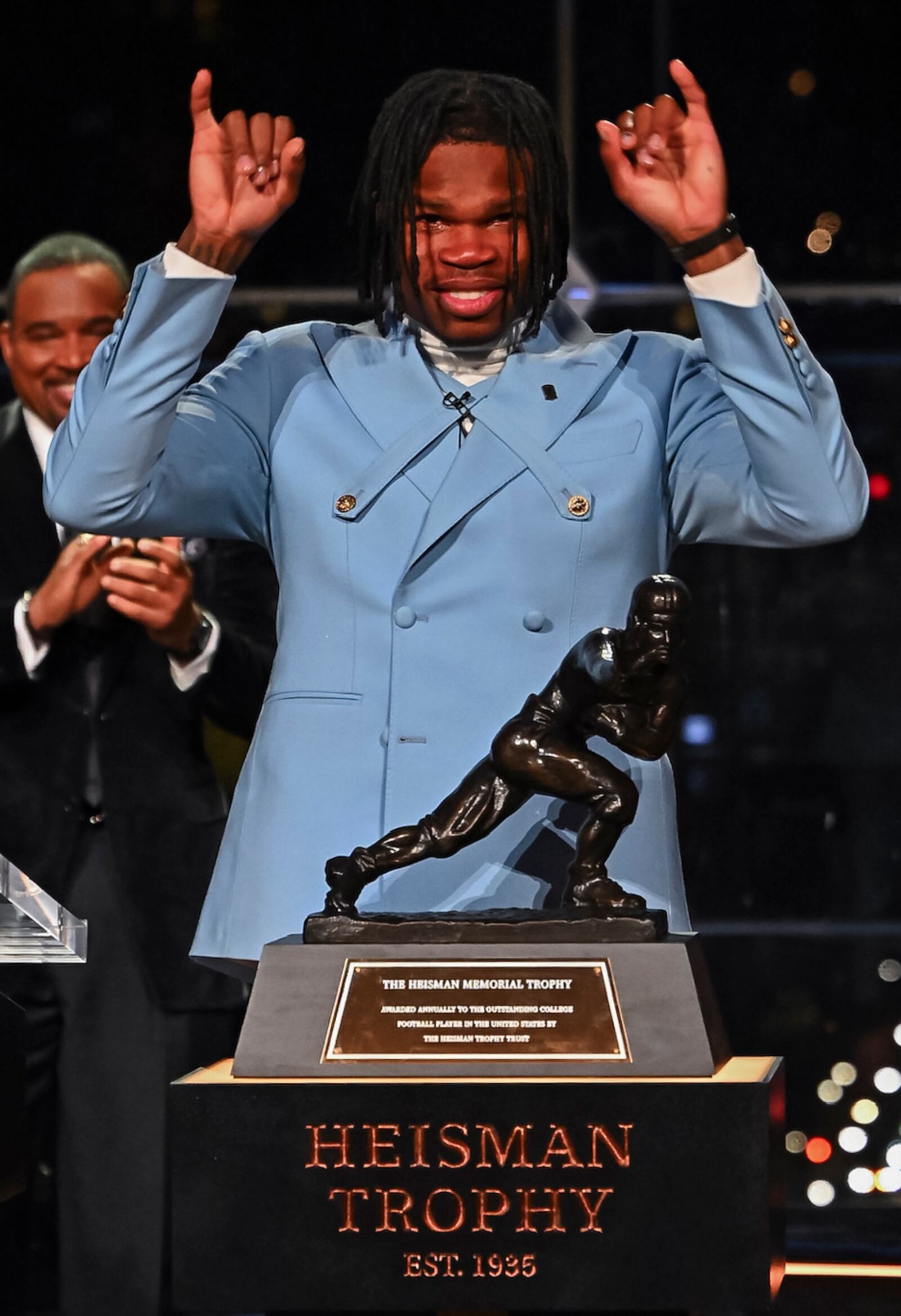 Colorado’s Travis Hunter gestures after winning the Heisman Trophy as the outstanding player in college football, Saturday, Dec. 14, 2024, in New York. (Todd Van Emst/Heisman Trust via AP, Pool)