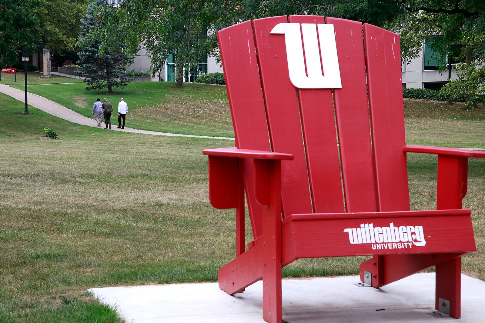 Three men walk across the campus of Wittenberg University Thursday, August 1, 2024. BILL LACKEY/STAFF