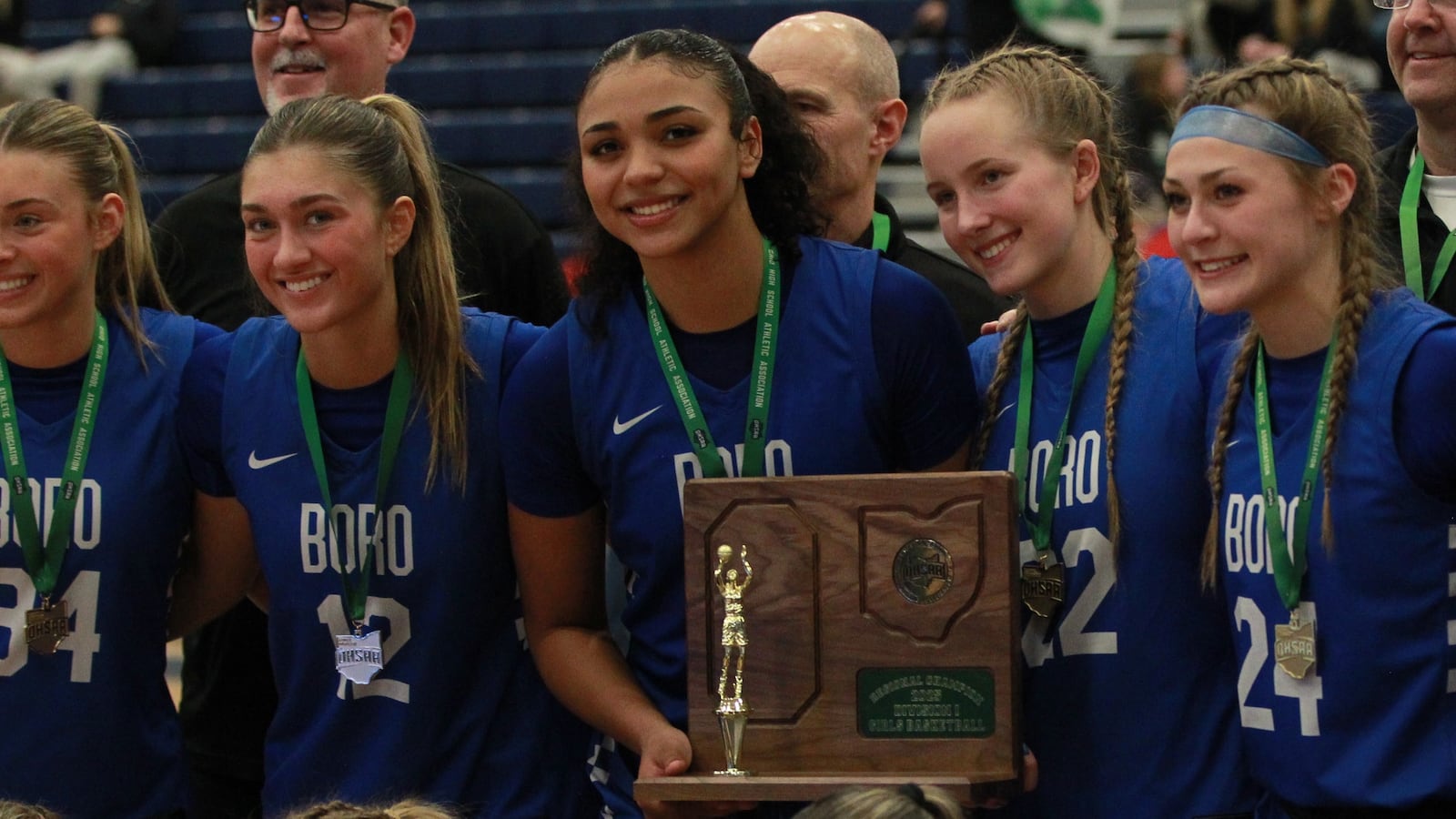 Bryn Martin (12), Aniya Trent (30), Lydia Gabbard (22) and Ava Wade (24) Springboro downed Mason on Saturday night March 1, 2025 at Fairborn to win the Southwest regional championship in girls basketball for the second straight year.