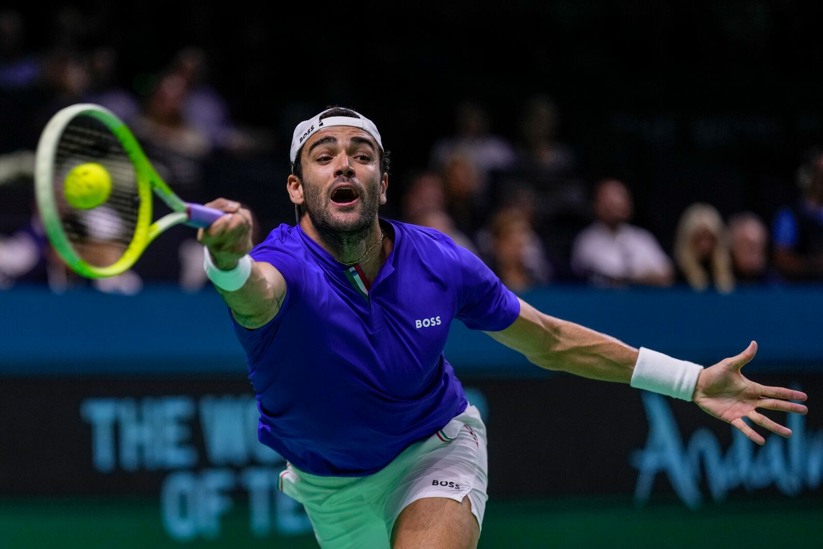 Italy's Matteo Berrettini returns the ball against Australia's Thanasi Kokkinakis during the Davis Cup semifinal at the Martin Carpena Sports Hall in Malaga, southern Spain, on Saturday, Nov. 23, 2024. (AP Photo/Manu Fernandez)