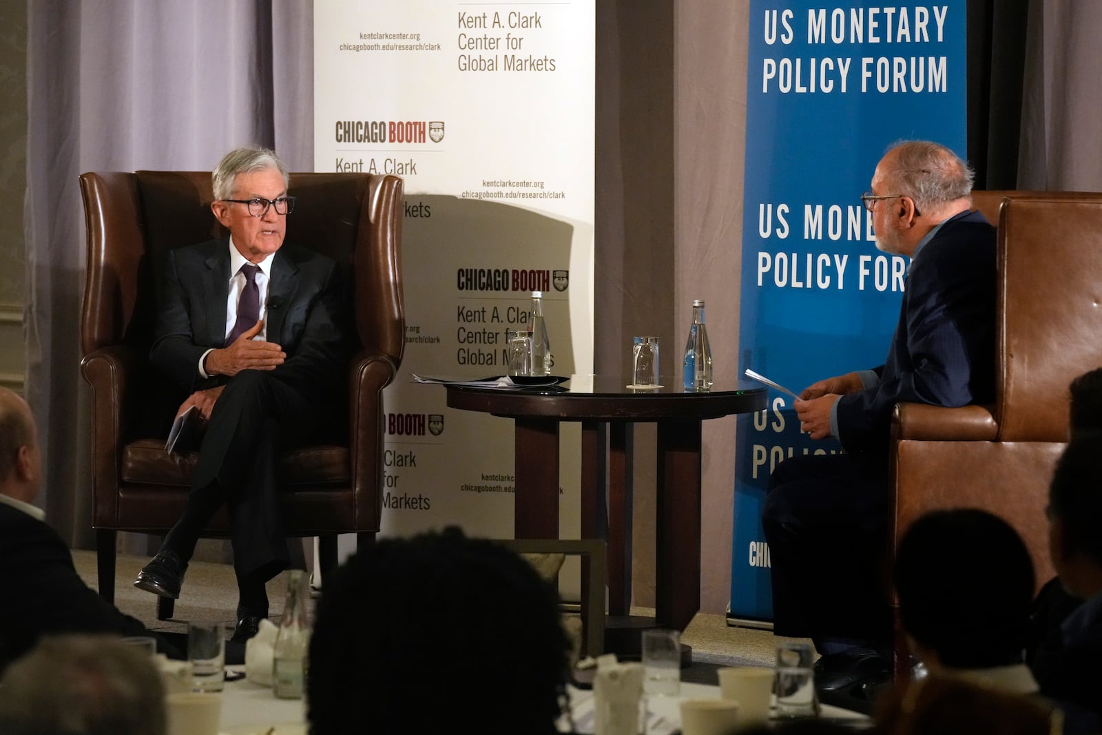 Federal Reserve Chair Jerome Powell, left, and Anil Kashyap, Professor of Economics and Finance at the University of Chicago's Booth School of Business, talk after Powell's address to the annual U.S. Monetary Policy Forum, in New York, Friday, March 7, 2025. (AP Photo/Richard Drew),