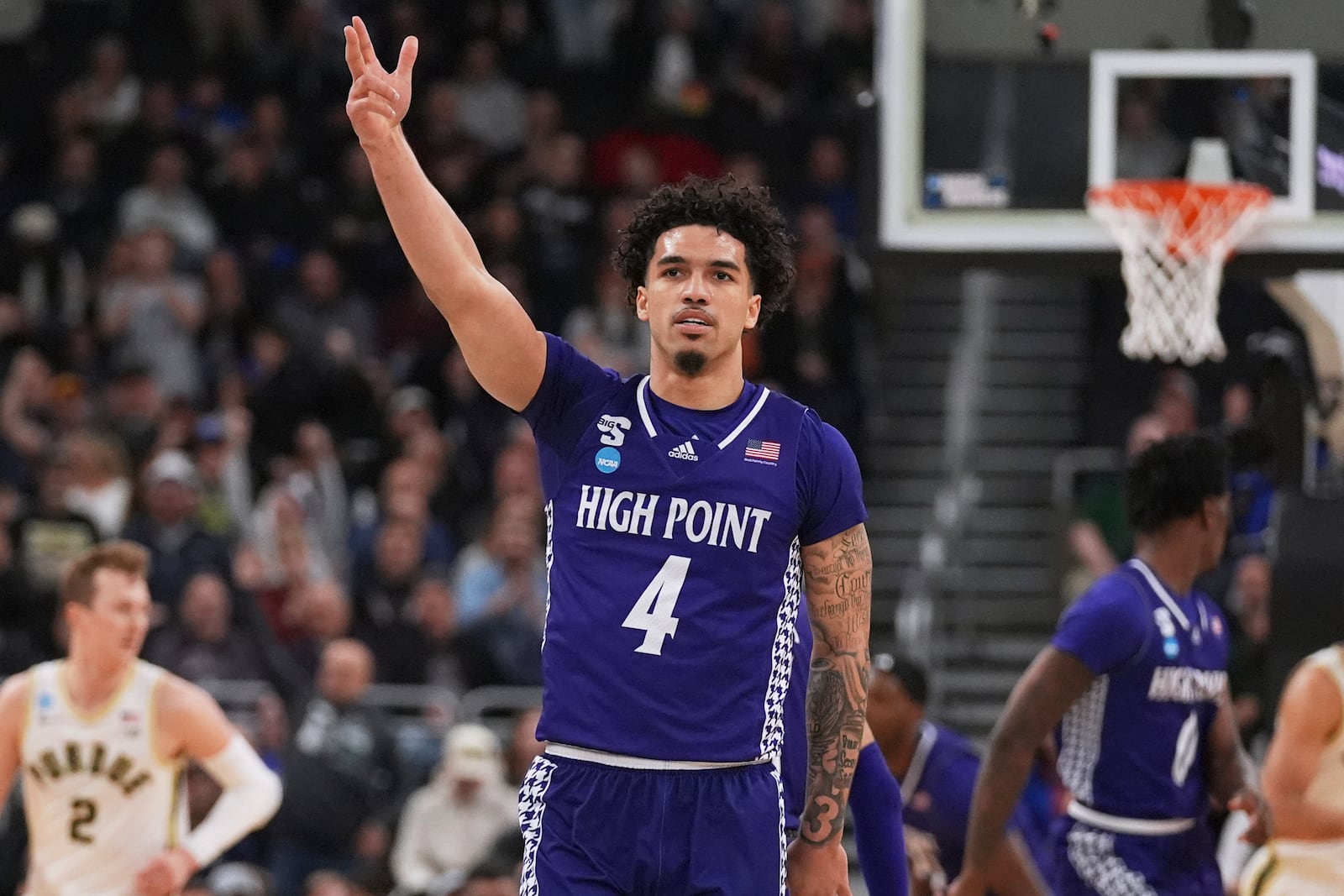 High Point guard D'Maurian Williams (4) celebrates after hitting a 3-pointer against Purdue during the first half in the first round of the NCAA college basketball tournament, Thursday, March 20, 2025, in Providence, R.I. (AP Photo/Charles Krupa)