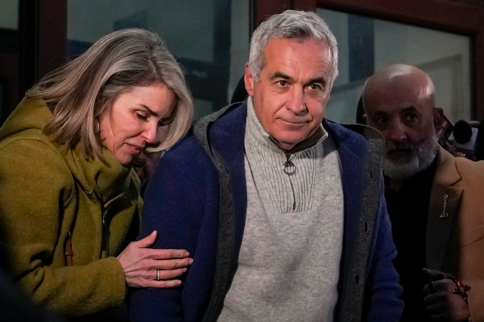 Calin Georgescu, the winner of Romania's first round of presidential election, annulled by the Constitutional Court, and his wife Cristela, leave the prosecutors office after being stopped in traffic and taken in for questioning in Bucharest, Romania, Wednesday, Feb. 26, 2025. (AP Photo/Vadim Ghirda)