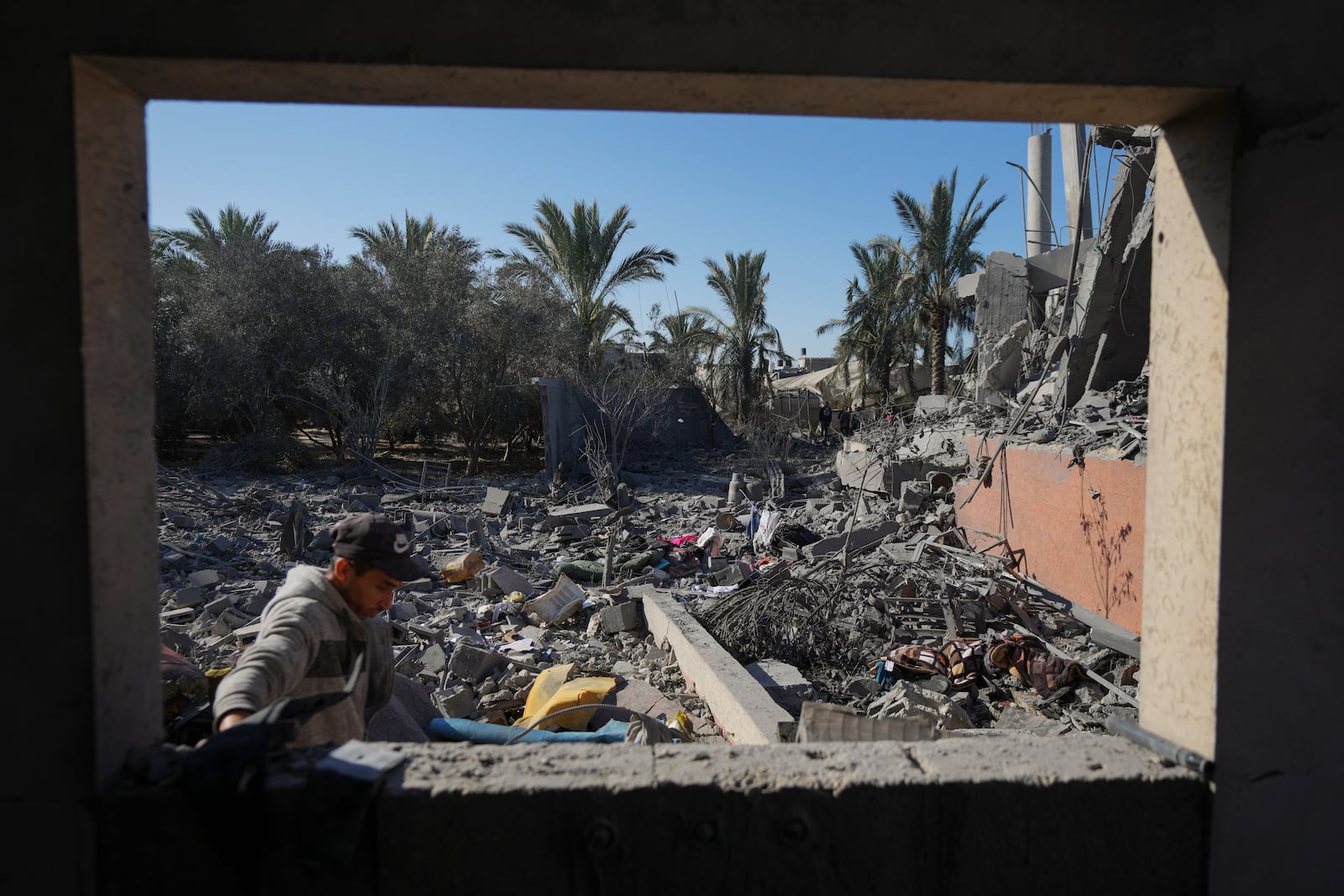 A Palestinian inspects the rubble of a destroyed building following an overnight Israeli strike in Deir al-Balah, Gaza Strip, Wednesday, Dec. 4, 2024. (AP Photo/Abdel Kareem Hana)