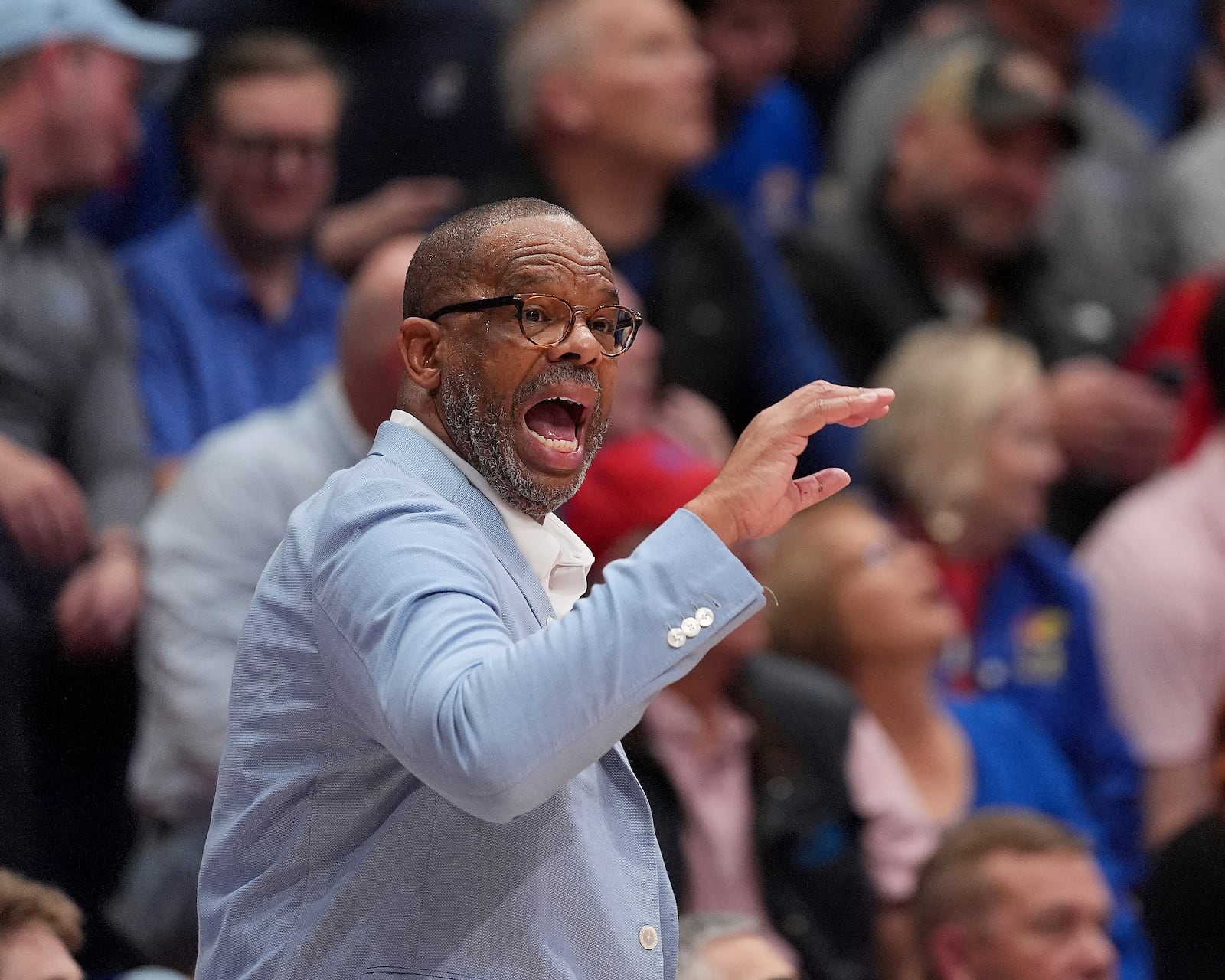 North Carolina head coach Hubert Davis talks to his players during the first half of an NCAA college basketball game against Kansas Friday, Nov. 8, 2024, in Lawrence, Kan. (AP Photo/Charlie Riedel)