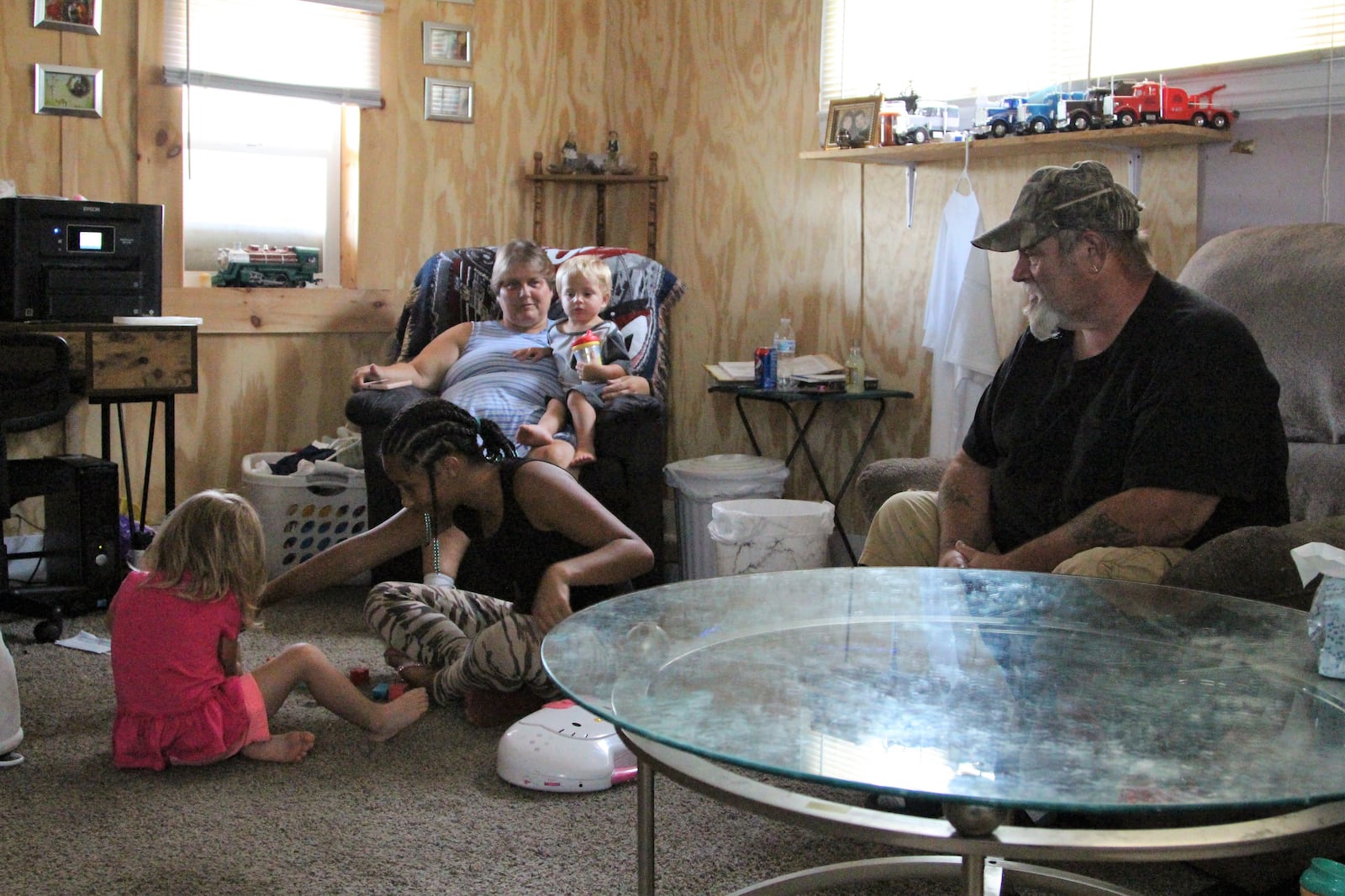 Junie Whitt watches his grandchildren play inside his Springfield home. Whitt lost two of his sons last Saturday in a fatal crash in Champaign County. Junie said he is still processing the loss. Hasan Karim/Staff