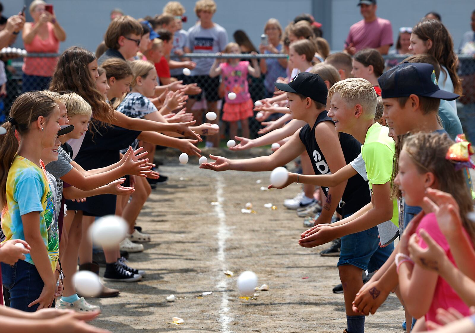 Young people compete in the egg toss event druing the Young Day activities Wednesday, August 9, 2023 at the Champaign County Fair. BILL LACKEY/STAFF