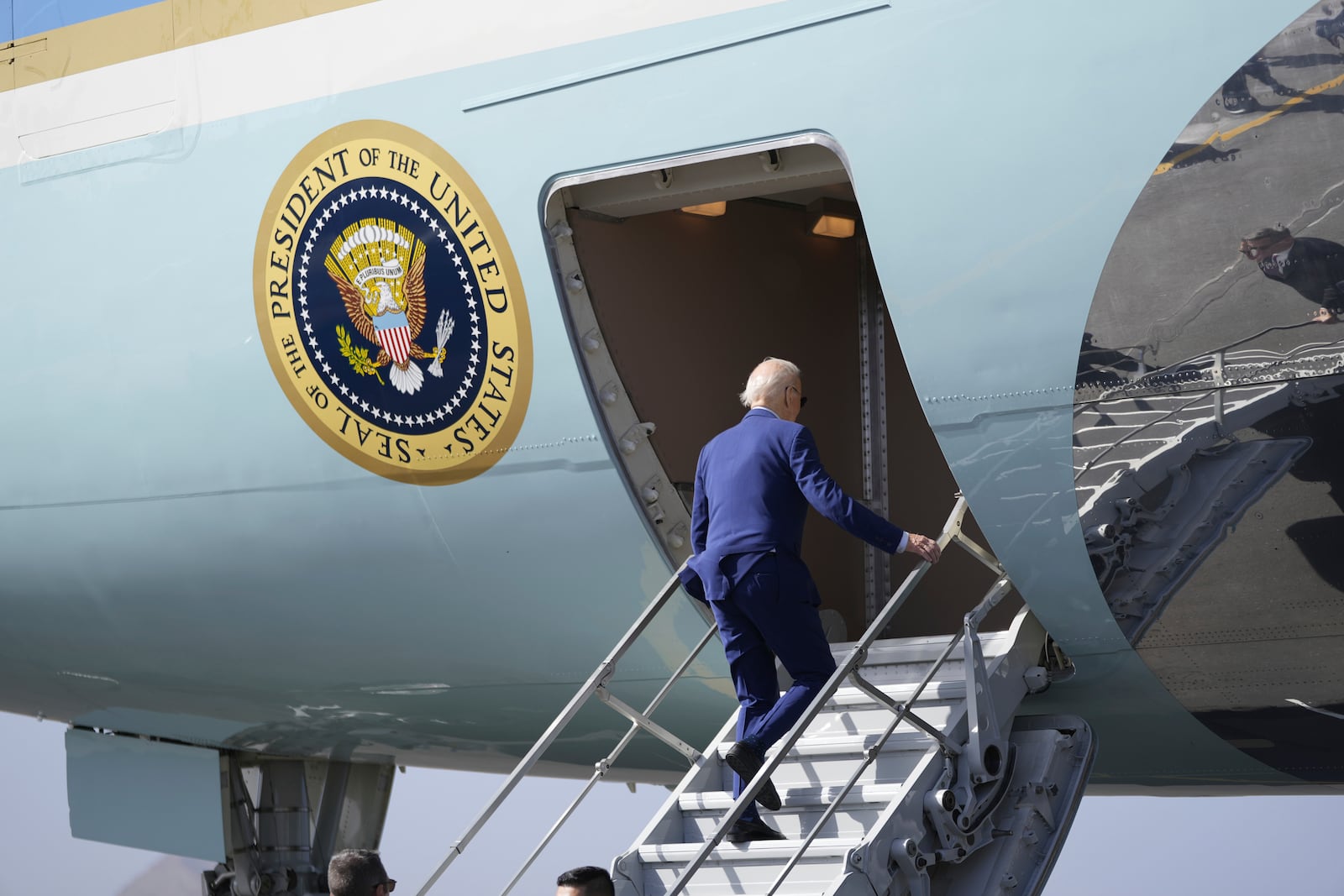 President Joe Biden boards Air Force One at Amilcar Cabral international airport on Sal island, Cape Verde Monday, Dec. 2, 2024, en route to Angola as he makes his long-promised visit to Africa. (AP Photo/Ben Curtis)