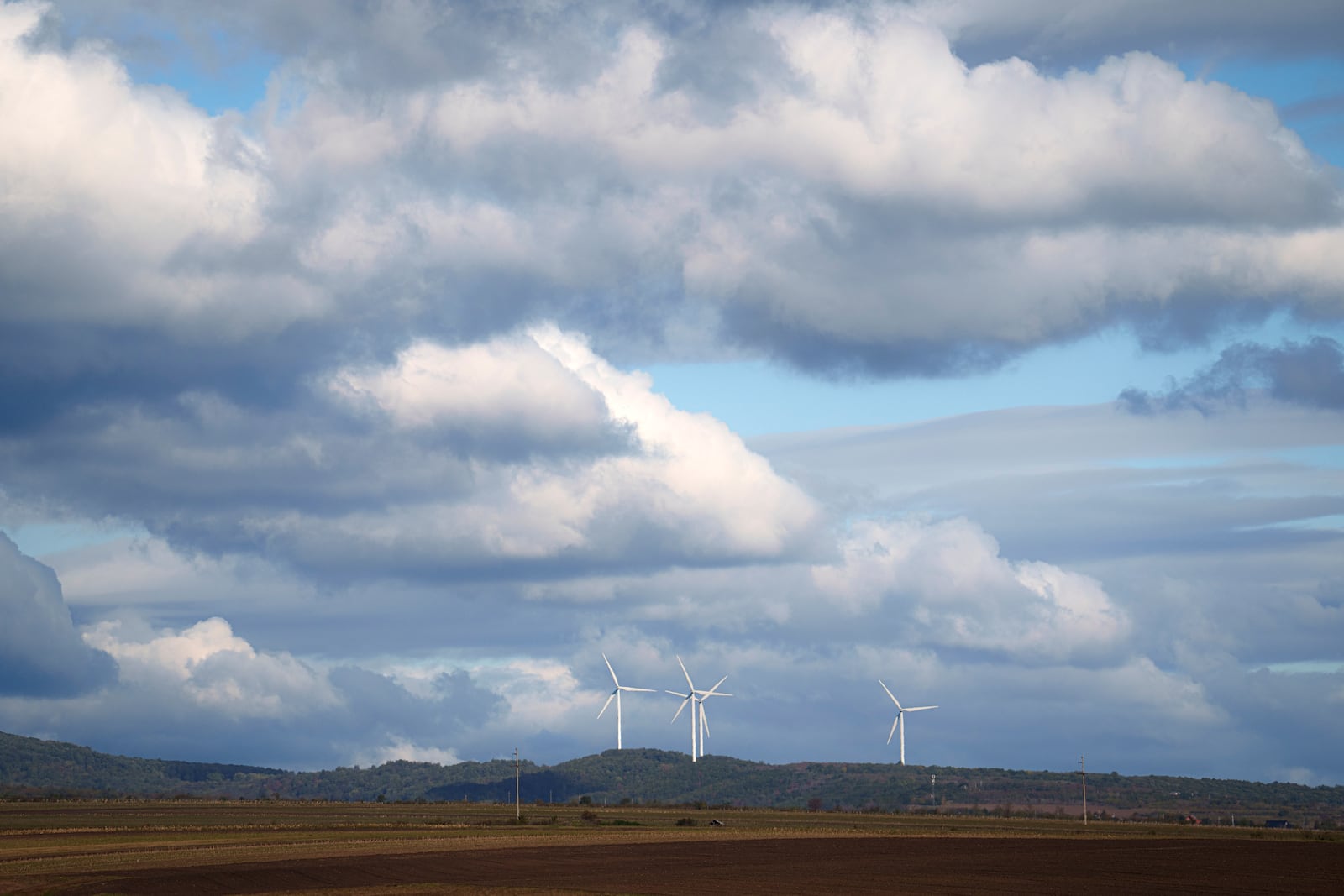 Wind turbines operate in the hills outside Focsani, western Romania, Wednesday, Oct. 16, 2024. (AP Photo/Vadim Ghirda)