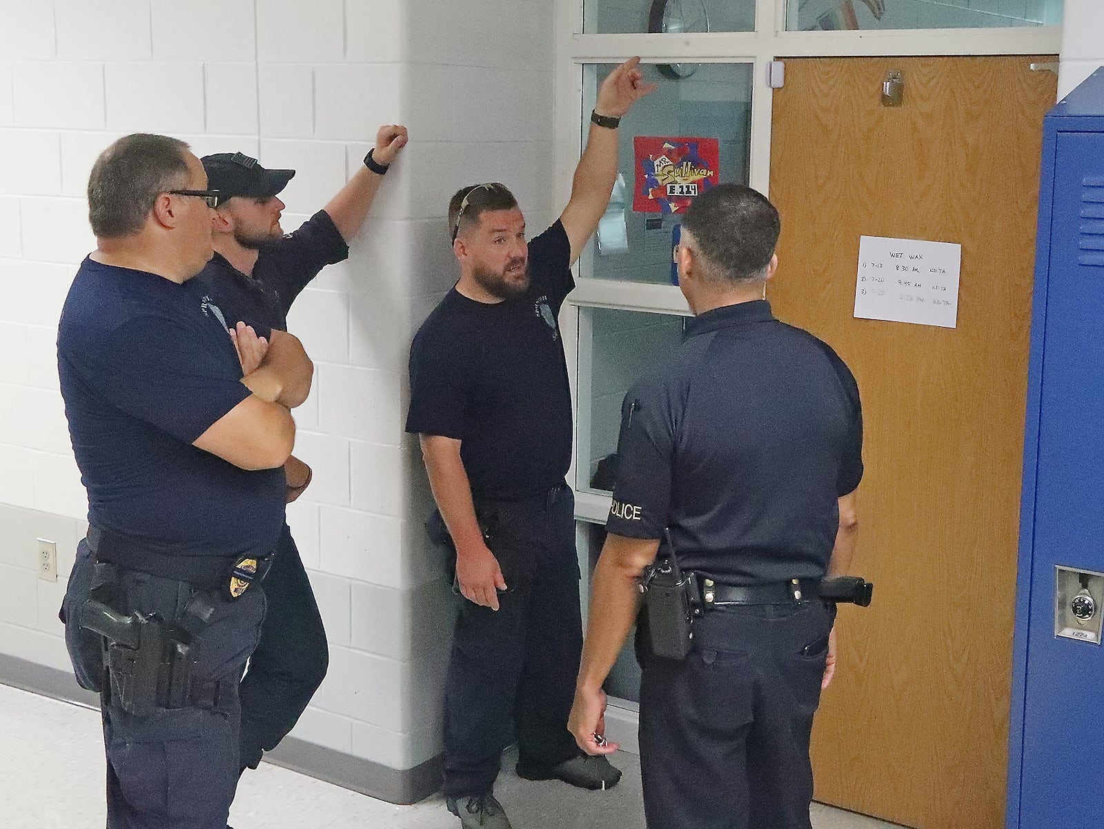 Members of the Springfield Police Division's SWAT team conduct a safety walk-through of Springfield High School Tuesday, August 9, 2022. BILL LACKEY/STAFF