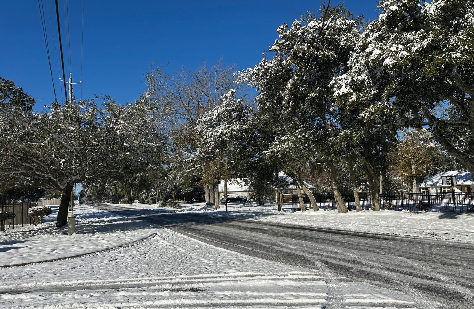 Second Street in Long Beach, Miss. Wednesday, Jan. 22, 2025 the day after a record snowstorm hit the Mississippi Gulf Coast. (Hunter Dawkins/The Gazebo Gazette via AP)