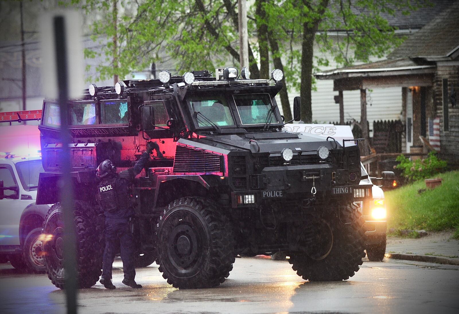 Members of the Springfield Police Division and SWAT team staged outside 905 Pleasant St., Friday evening May 6, 2022. MARSHALL GORBY \STAFF