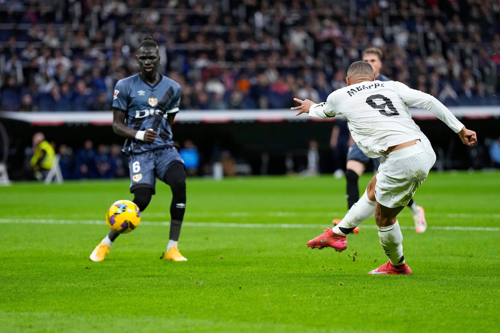 Real Madrid's Kylian Mbappe scores his side's opening goal during the Spanish La Liga soccer match between Real Madrid and Rayo Vallecano at the Santiago Bernabeu stadium in Madrid, Spain, Sunday, March 9, 2025. (AP Photo/Manu Fernandez)