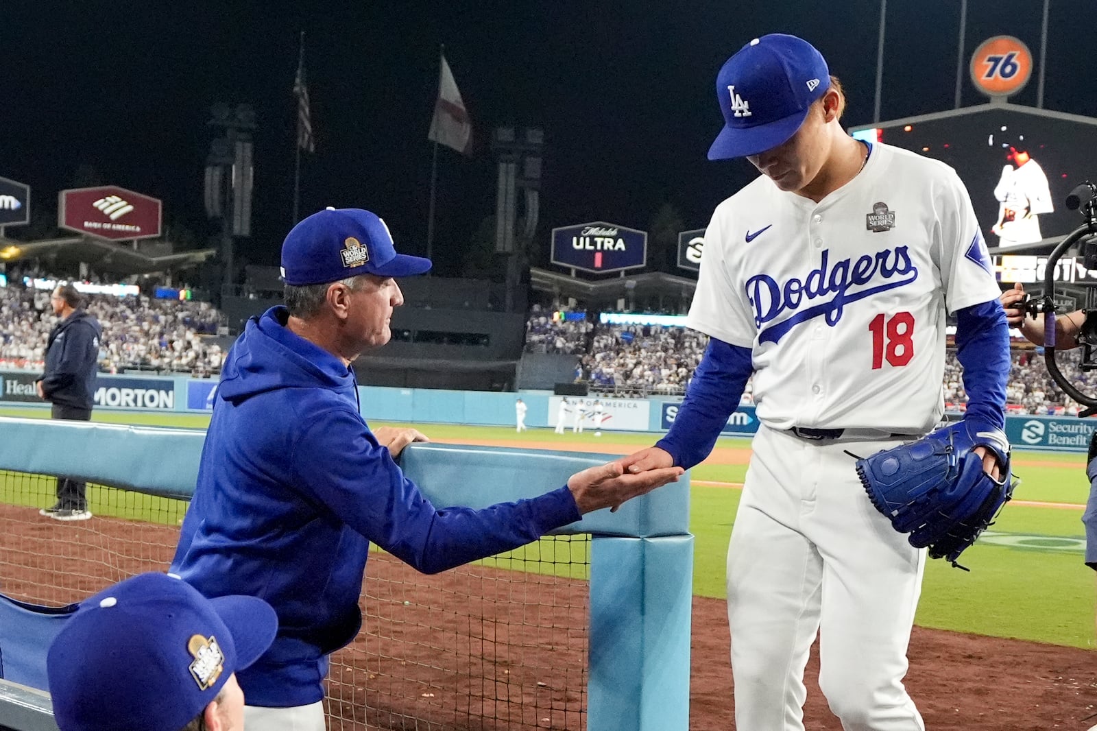 Los Angeles Dodgers pitcher Yoshinobu Yamamoto leaves the games against the New York Yankees during the seventh inning in Game 2 of the baseball World Series, Saturday, Oct. 26, 2024, in Los Angeles. (AP Photo/Ashley Landis)