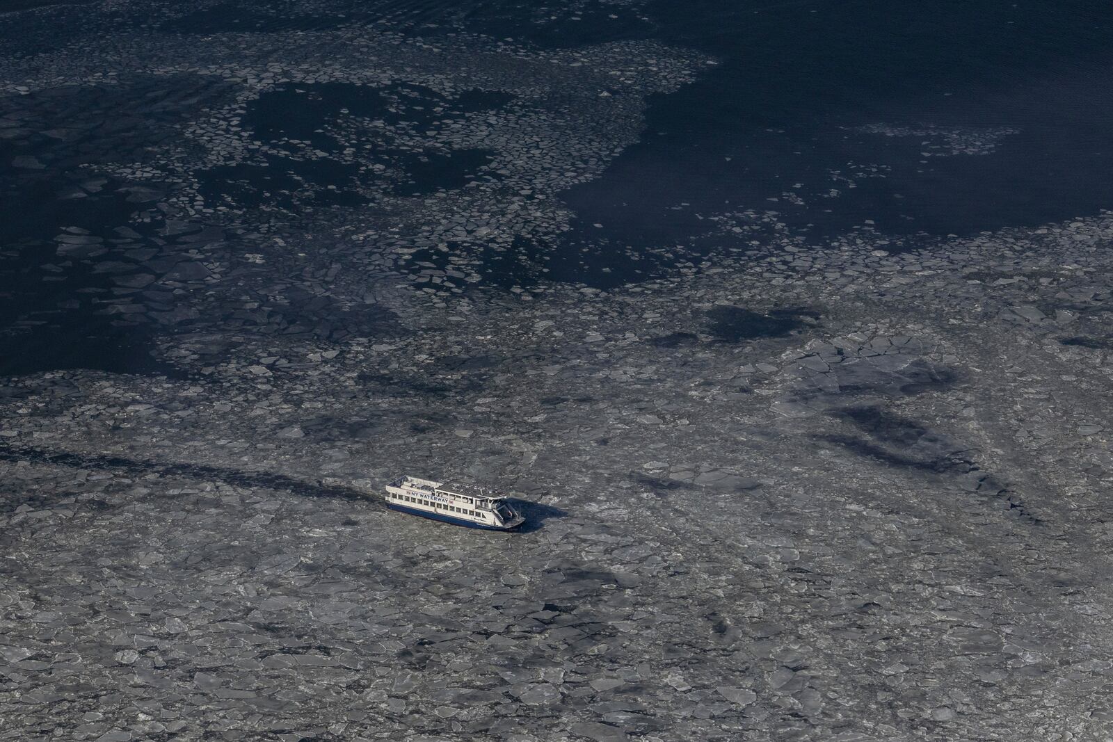 A boat moves as ice floats on the Hudson River seen at the Edge at Hudson Yards, Thursday, Jan. 23, 2025, in New York. (AP Photo/Yuki Iwamura)