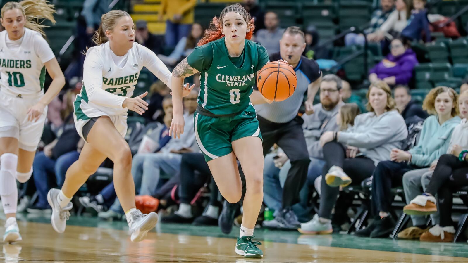 Cleveland State University's Mickayla Perdue, a Springfield High School graduate, is chased by Wright State University's Macie Taylor during their game on Wednesday, Jan. 17. Michael Cooper/CONTRIBUTED