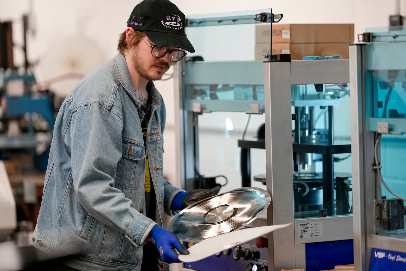 Graham Purrell prepares a master plate for creating vinyl records at the United Record Pressing plant July 11, 2024, in Nashville, Tenn. (AP Photo/George Walker IV)