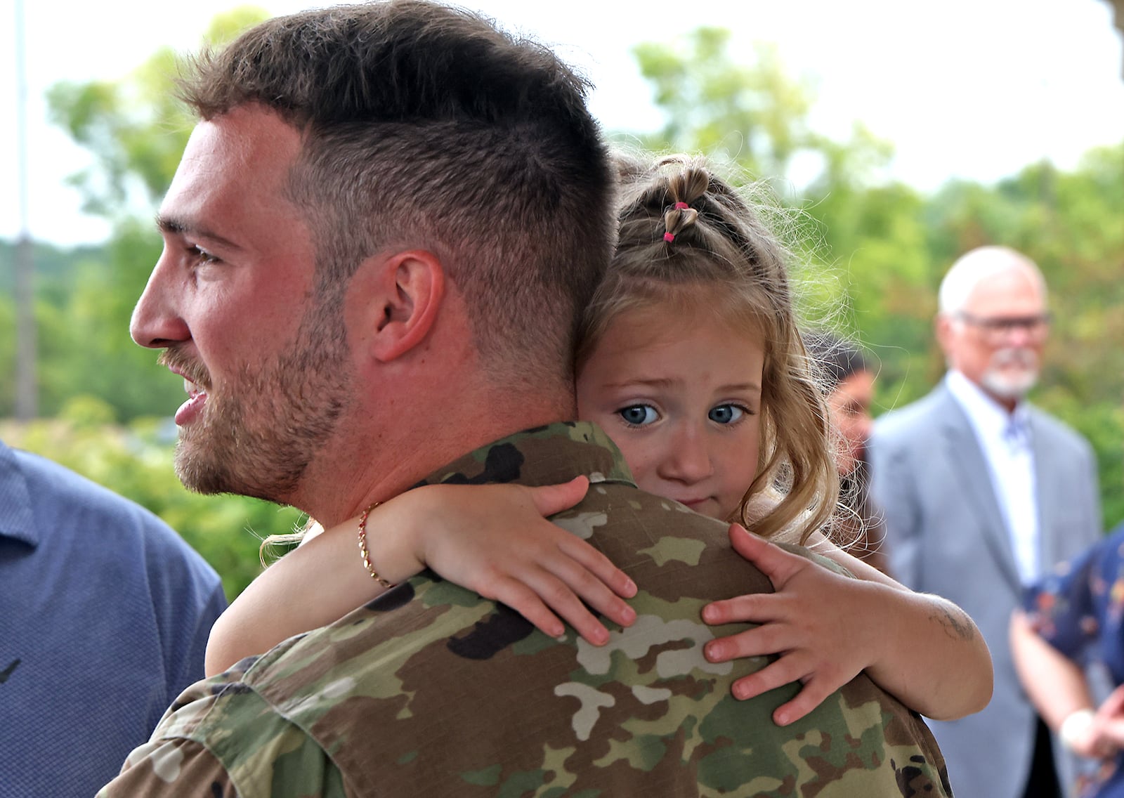 Caroline Bernhardt hangs onto her father, Sgt. Kolton Bernhardt of the Ohio Army National Guard 1137th Tactical Installation Networking Enhanced Signal Company, following a Call to Duty Ceremony for the unit Saturday, August 31, 2024 at the First Christian Church in Springfield. BILL LACKEY/STAFF