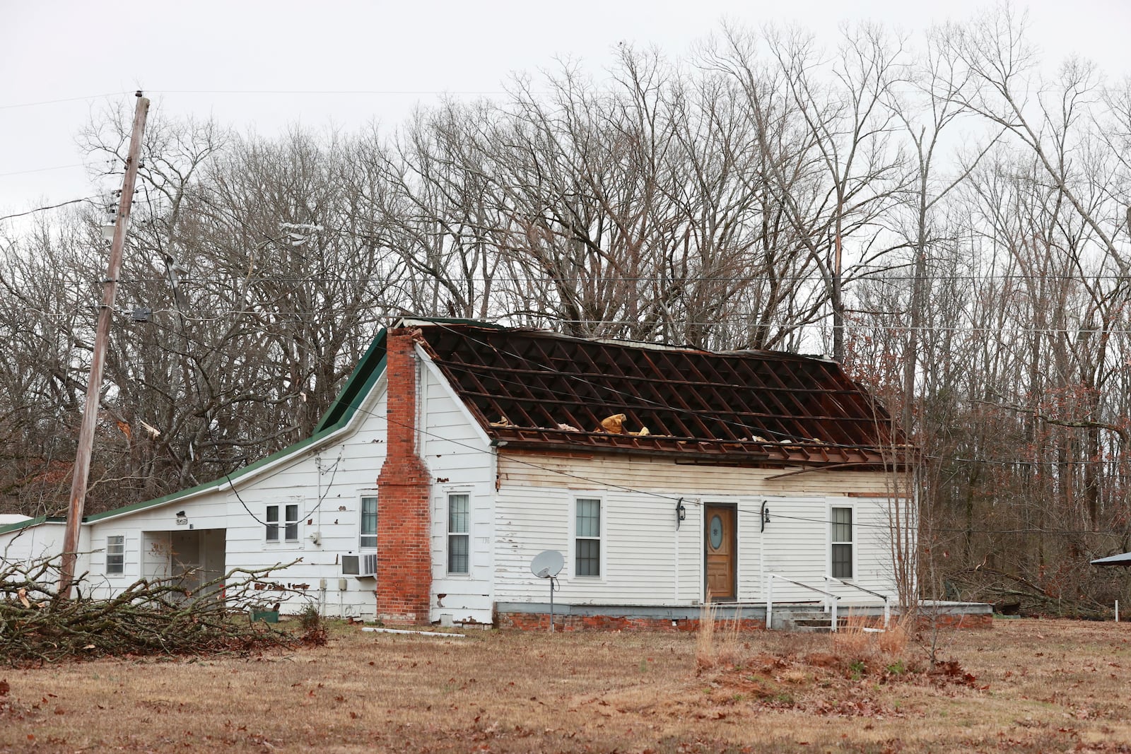 A roof was ripped off and flipped over on a home along Lee County Rd. 449 in Shannon, Miss. during Saturday nights severe thunderstorms that passed through the state. (Thomas Wells/The Northeast Mississippi Daily Journal via AP)