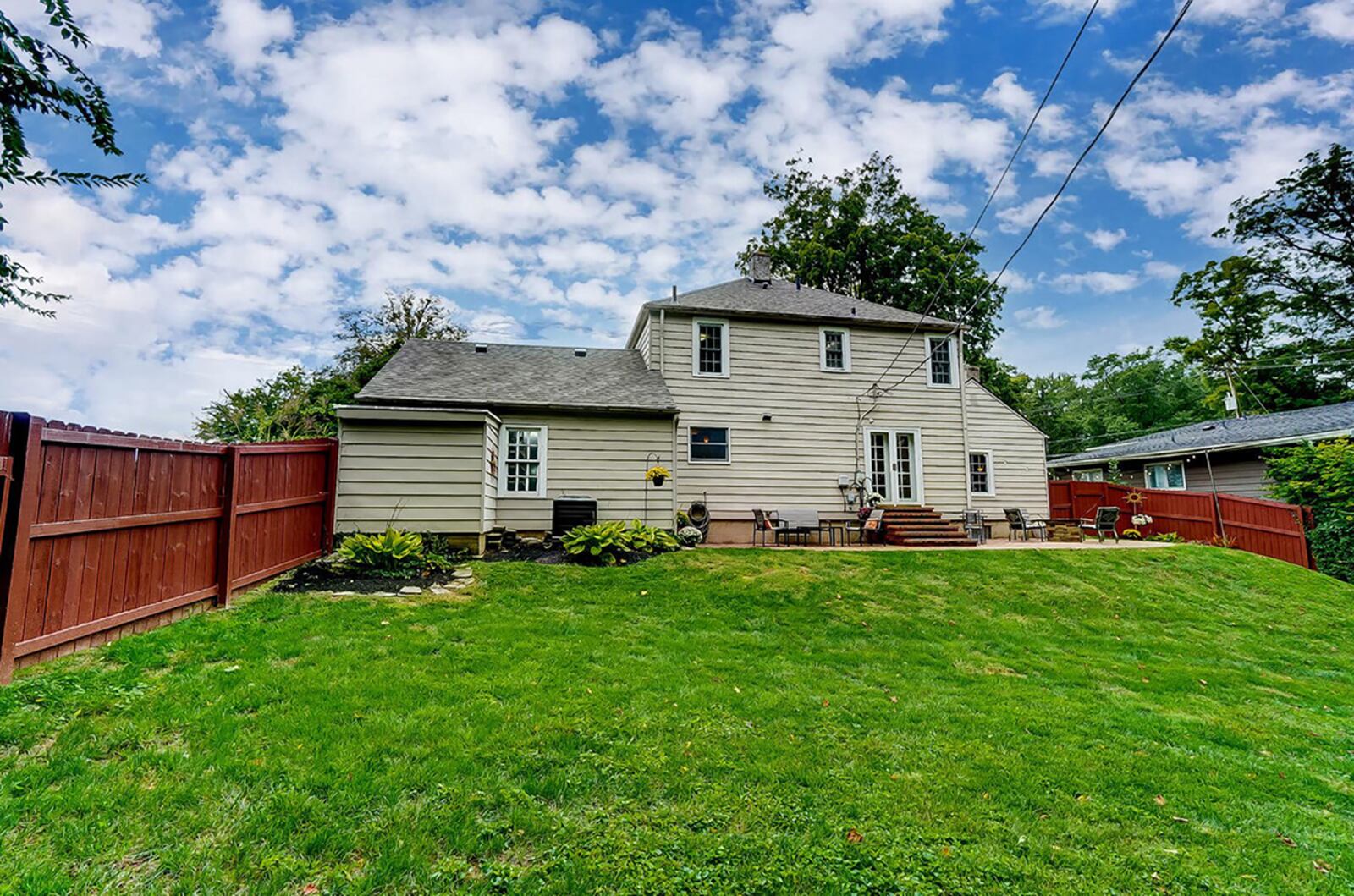 The rear of the home has brick steps leading to the paver patio and a wood privacy fence recently added to the home. CONTRIBUTED PHOTO