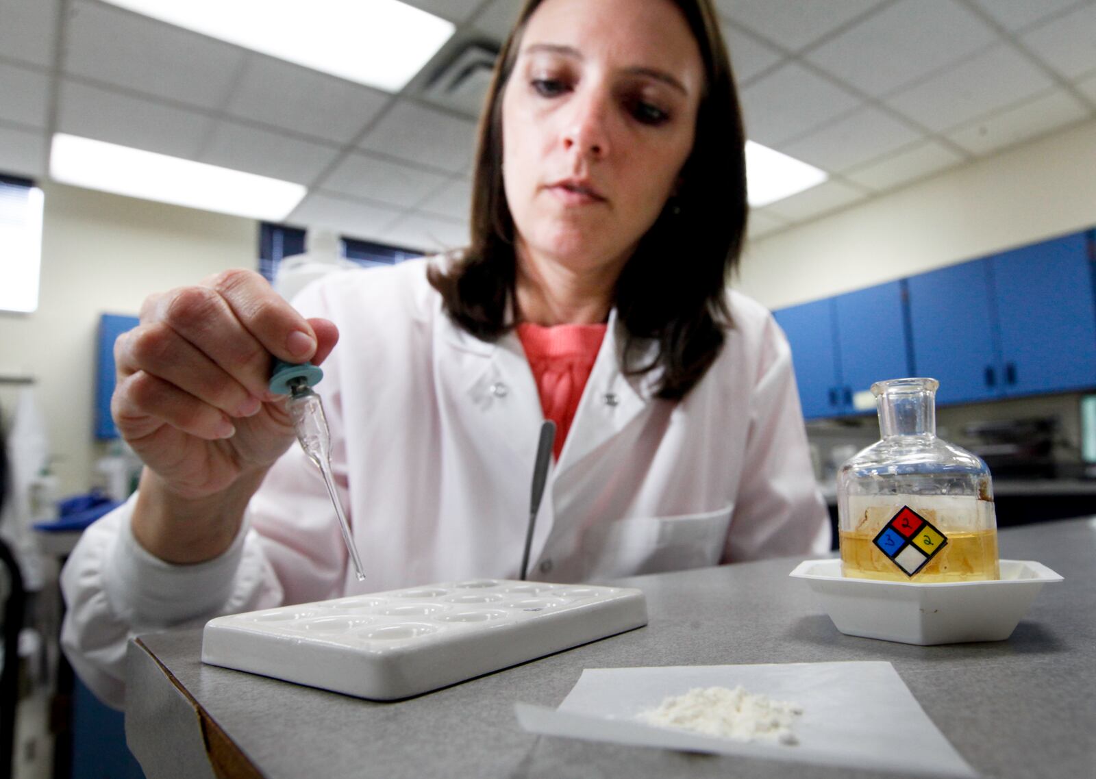 Brooke Ehlers, of the Miami Valley Regional Crime Laboratory, tests a drug sample for fentanyl. CHRIS STEWART / FILE PHOTO