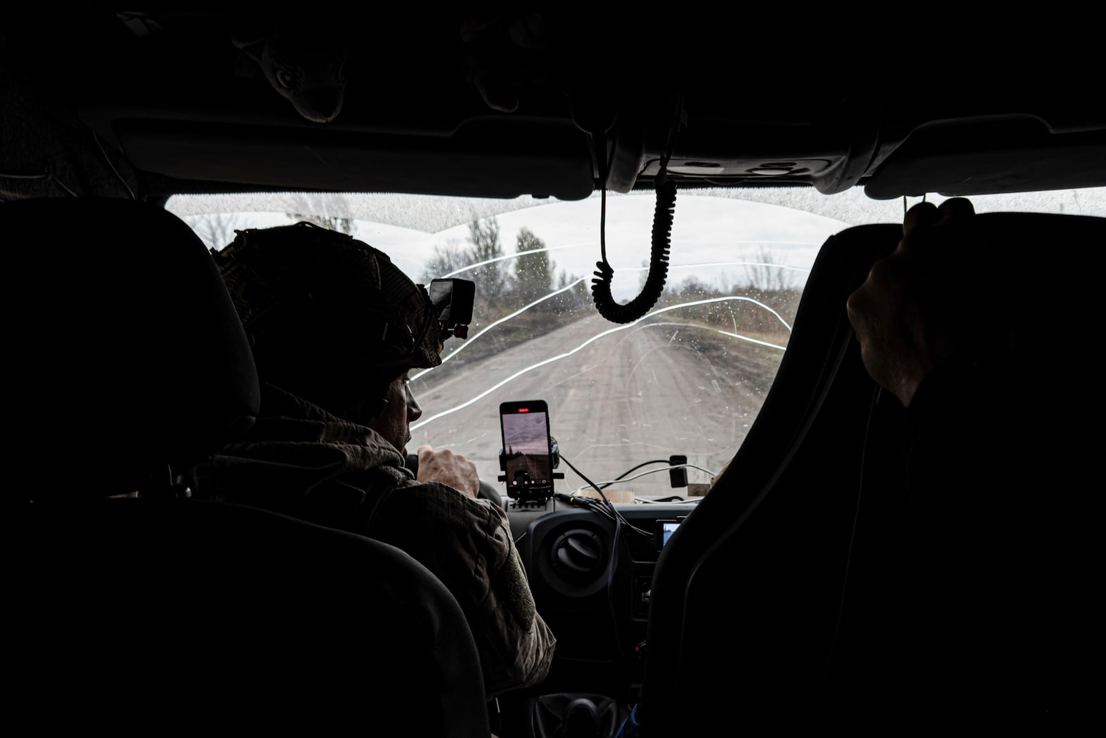 Pipa Vasyl, a policeman of the "White Angels" drives in an armoured minivan during en evacuation in Kurakhove, Donetsk region, Ukraine, on Nov. 4, 2024. (AP Photo/Anton Shtuka)