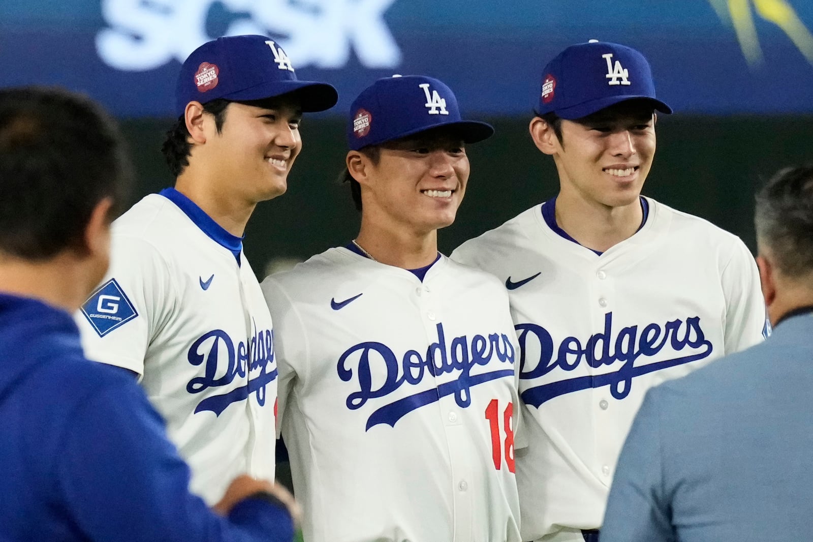 Los Angeles Dodgers' Shohei Ohtani, left, Yoshinobu Yamamoto, center, and Roki Sasaki, right, pose for a photo after the team's win in an MLB Tokyo Series baseball game against the Chicago Cubs in Tokyo, Japan, Wednesday, March 19, 2025. (AP Photo/Eugene Hoshiko)