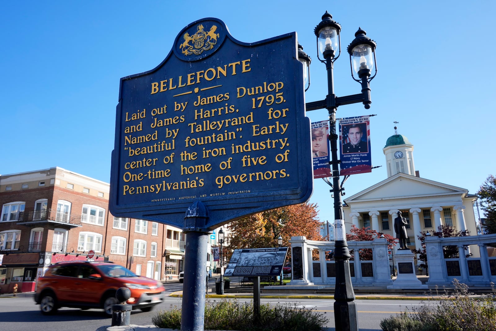 A historical marker stands in downtown Bellefonte, Pa., near the Centre County Courthouse, rear right, Friday, Oct. 18, 2024. (AP Photo/Gene J. Puskar)