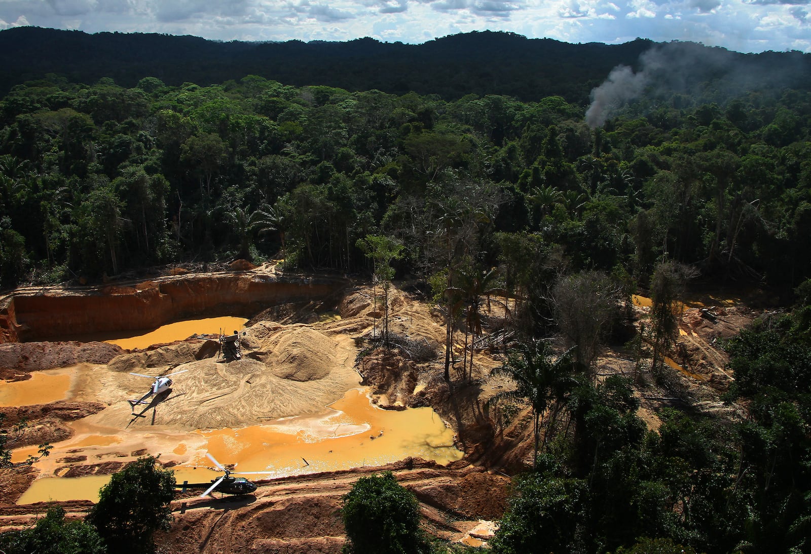 FILE - Brazil Environmental Agency helicopters fly over an illegal mining camp during an operation to try to contain the practice in Yanomami Indigenous territory, Roraima state, Brazil, Feb. 11, 2023. (AP Photo/Edmar Barros, File)