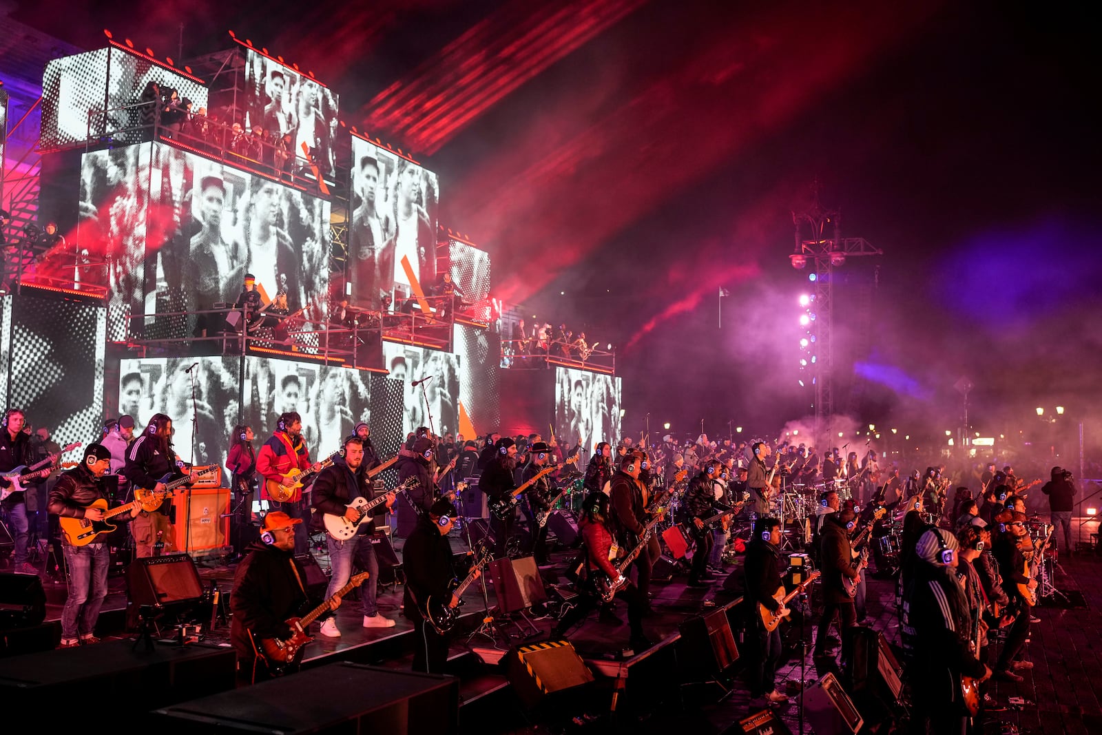 Musicians play on the stage during the concert for freedom for the 35th anniversary of the fall of the Berlin Wall, at the Brandenburg Gate in Berlin, Germany, Saturday, Nov. 9, 2024. (AP Photo/Ebrahim Noroozi)