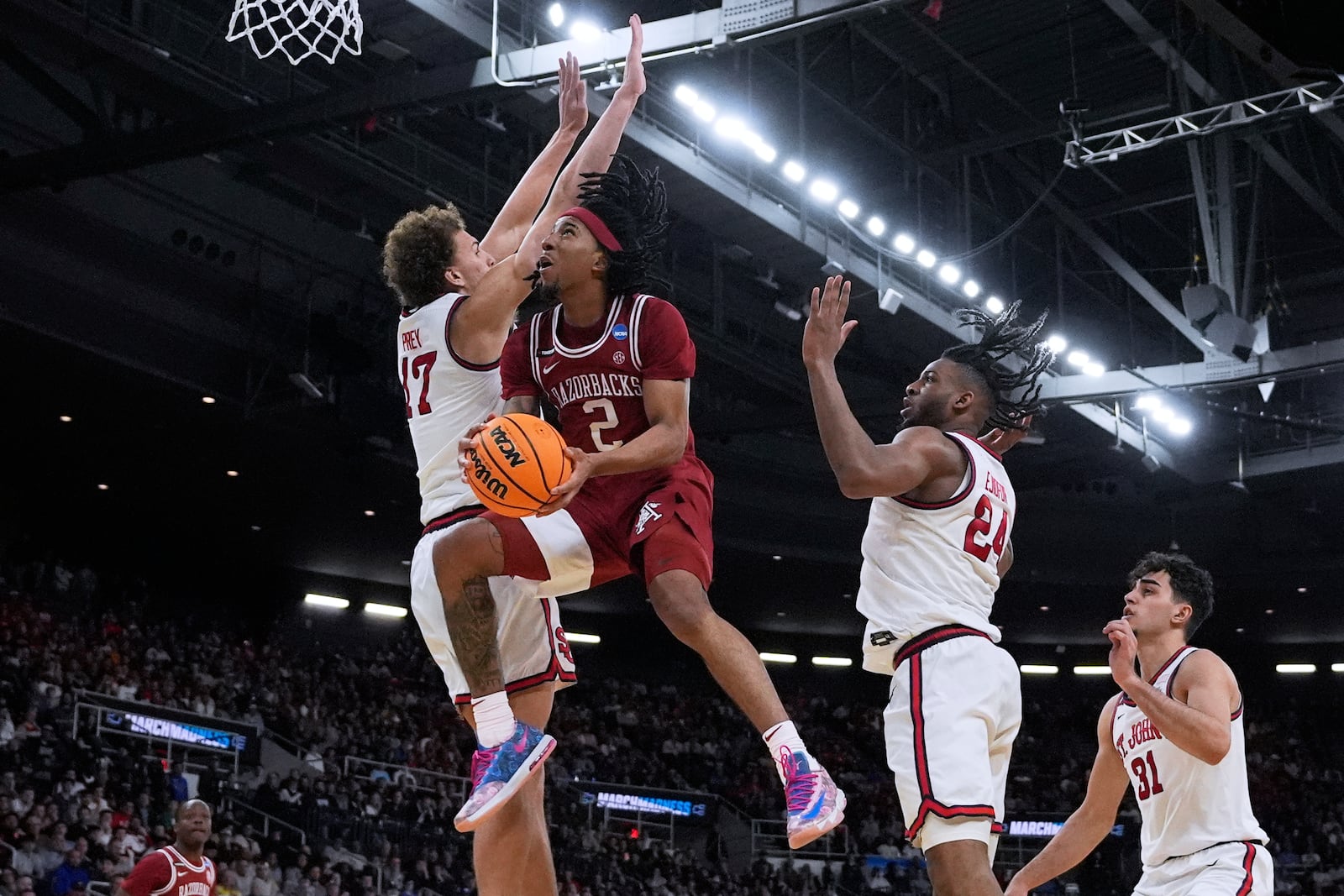 Arkansas guard Boogie Fland (2) drives the basket against St. John's during the second half in the second round of the NCAA college basketball tournament, Saturday, March 22, 2025, in Providence, R.I. (AP Photo/Charles Krupa)