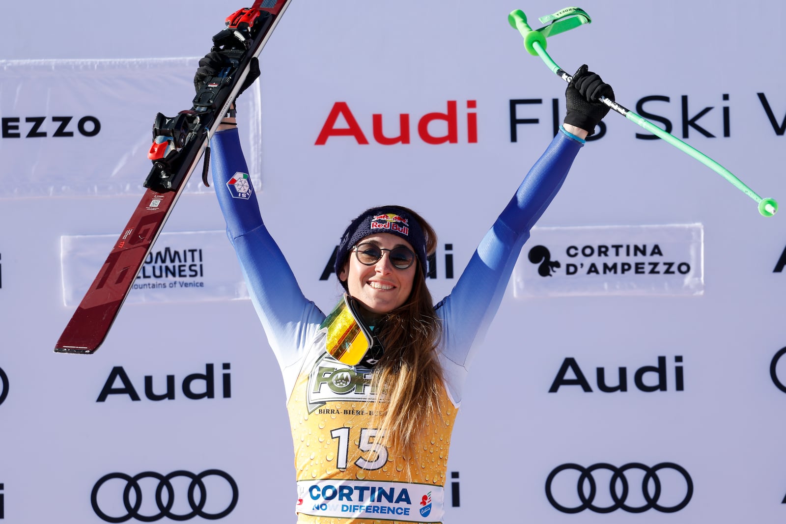 Italy's Sofia Goggia celebrates on the podium after winning an alpine ski, women's World Cup downhill, in Cortina d'Ampezzo, Italy, Saturday, Jan. 18, 2025 (AP Photo/Alessandro Trovati)