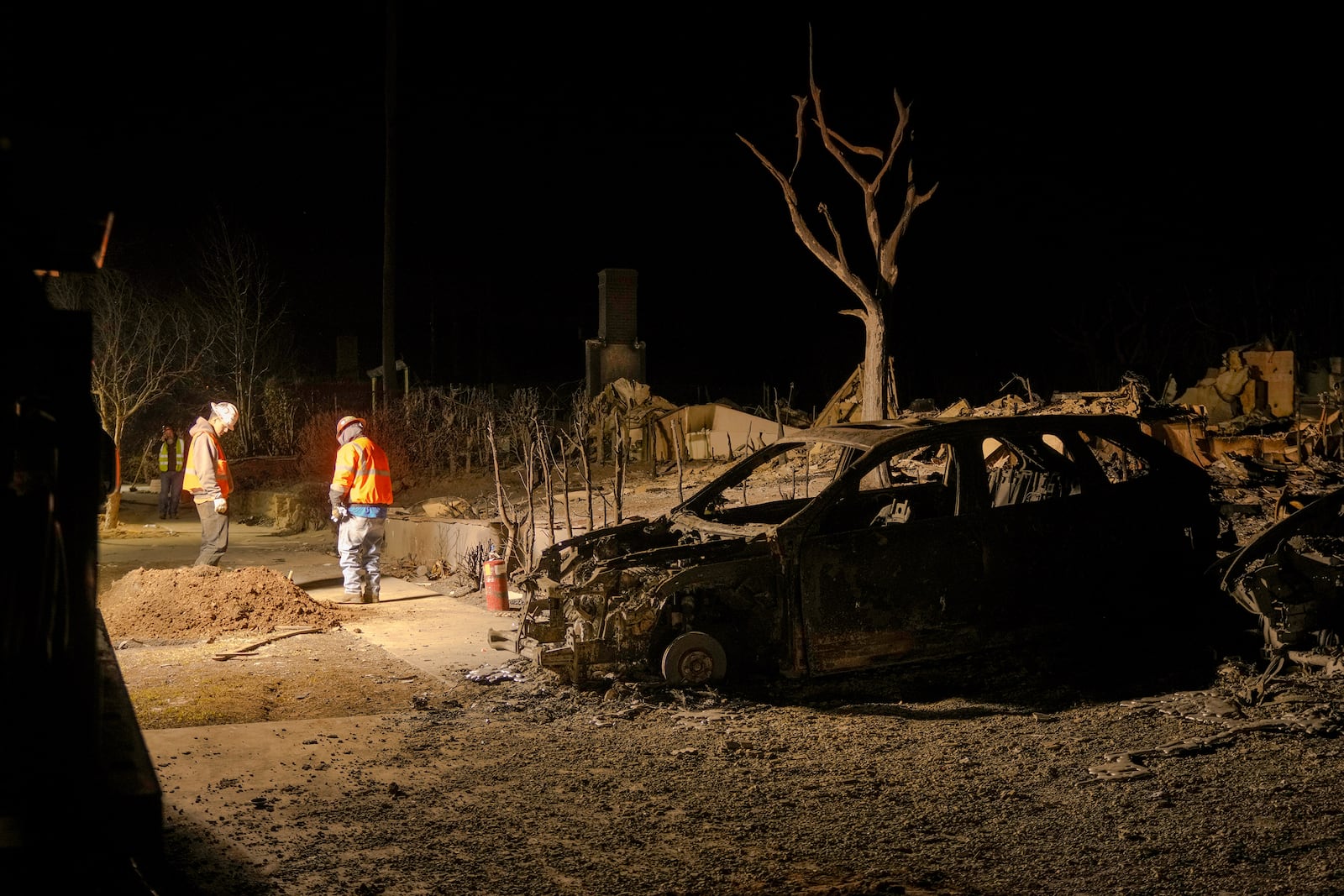 SoCalGas workers dig a trench to secure natural gas infrastructure of homes destroyed by the Palisades Fire in the Pacific Palisades neighborhood of Los Angeles, Thursday, Jan. 16, 2025. (AP Photo/Damian Dovarganes)