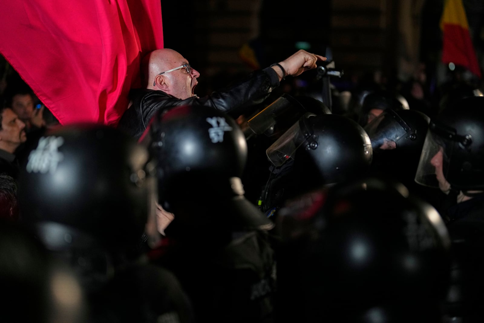 A supporter of Calin Georgescu reacts during a protest after Romania's electoral body rejected his candidacy in the presidential election rerun in Bucharest, Romania, Sunday, March 9, 2025. (AP Photo/Vadim Ghirda)