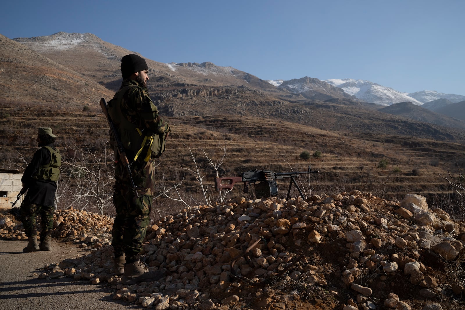 Members of the new security forces stand guard at a checkpoint located near the border with Lebanon, in the town of Serghaya, Syria, Tuesday, Jan. 7, 2025. (AP Photo/Leo Correa)